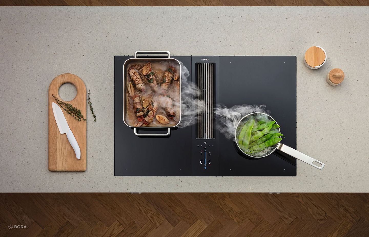 A large baking dish cools down on a Bora Classic 2.0 Combined Cooktop and Extractor