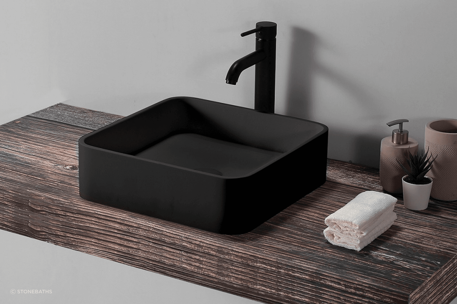 The beautiful B1700 Square Basin from Stonebaths the woooden panel adds a touch of natural beauty to the space