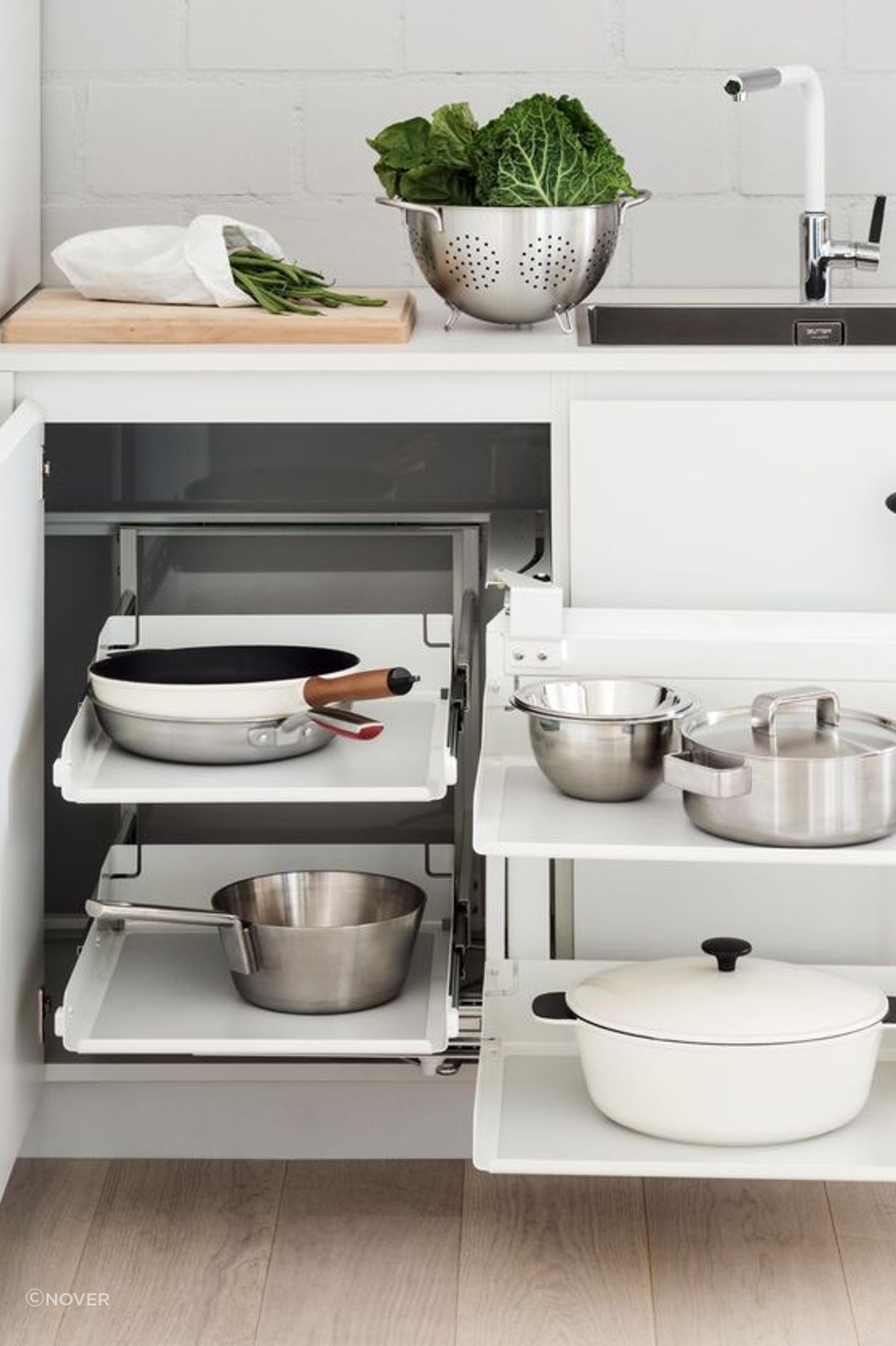 A colander in use, stored with other essentials in a Peka Magic Corner Storage Kit from Nover
