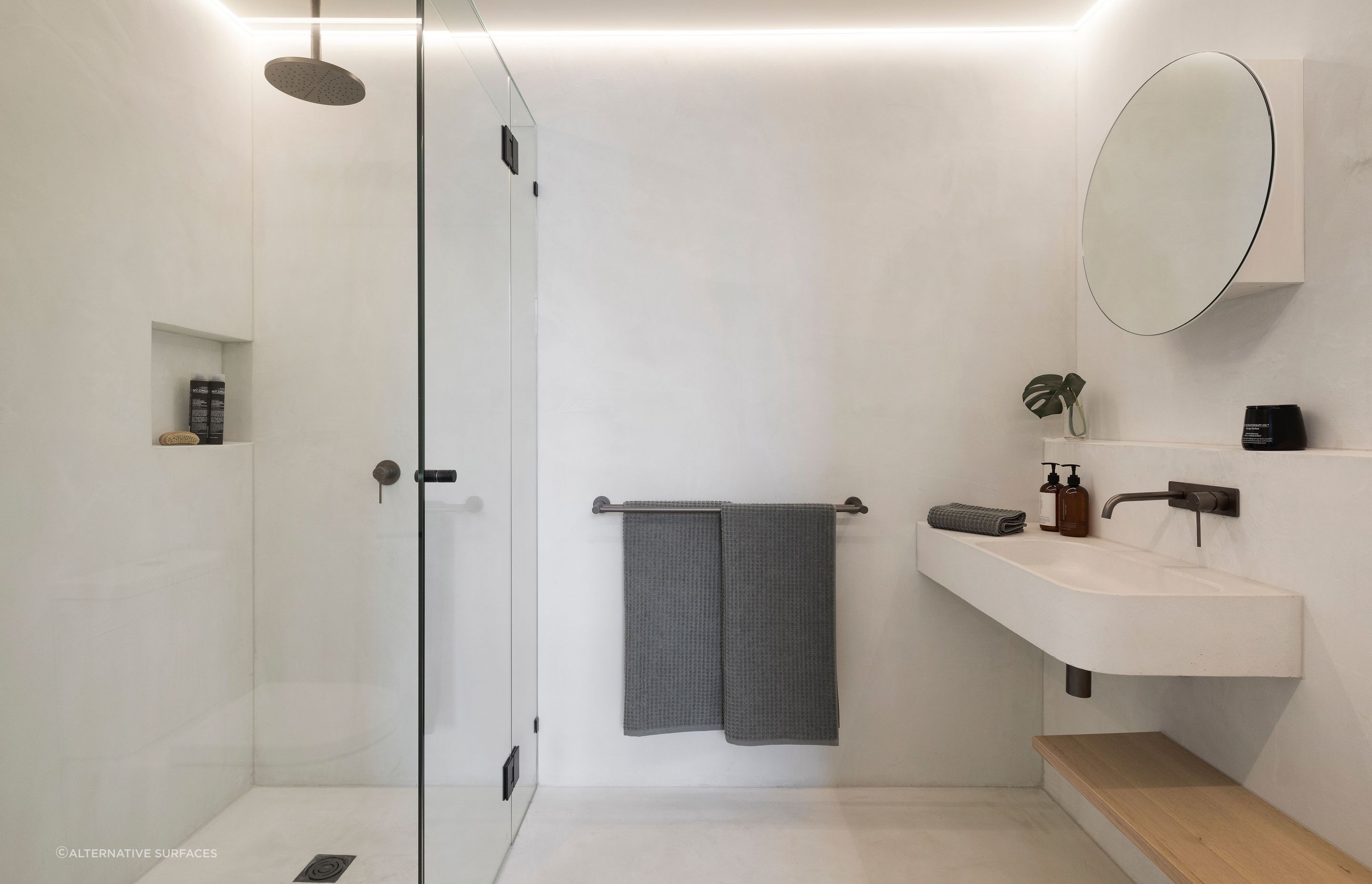 Strip lighting illuminates a minimalist bathroom at King St Townhouse - Photography: Dylan James Photo