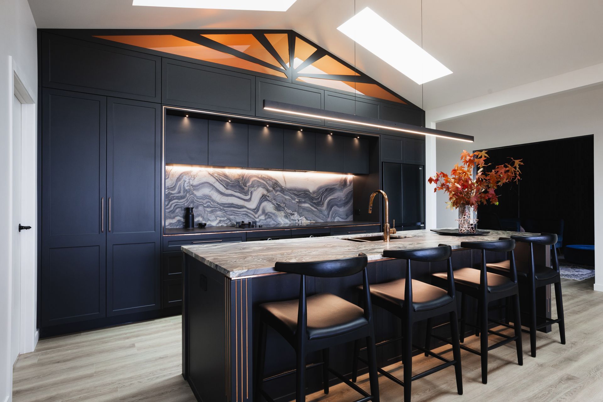 “To bring this ‘sunset’ to life, literally no stone was left unturned. We found the perfect quartzite splashback to set the scene, adding warm white lighting with no power point cutouts to enhance the elegance."