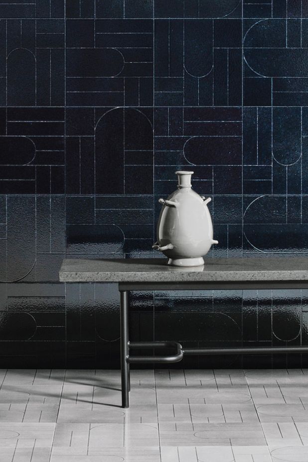 Teorema results from exploring primal symbols made up of minimal, austere signs achieved by incising glazed lava stone tiles.