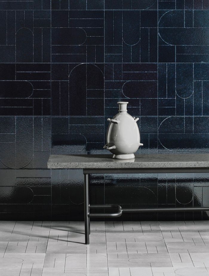Teorema results from exploring primal symbols made up of minimal, austere signs achieved by incising glazed lava stone tiles.