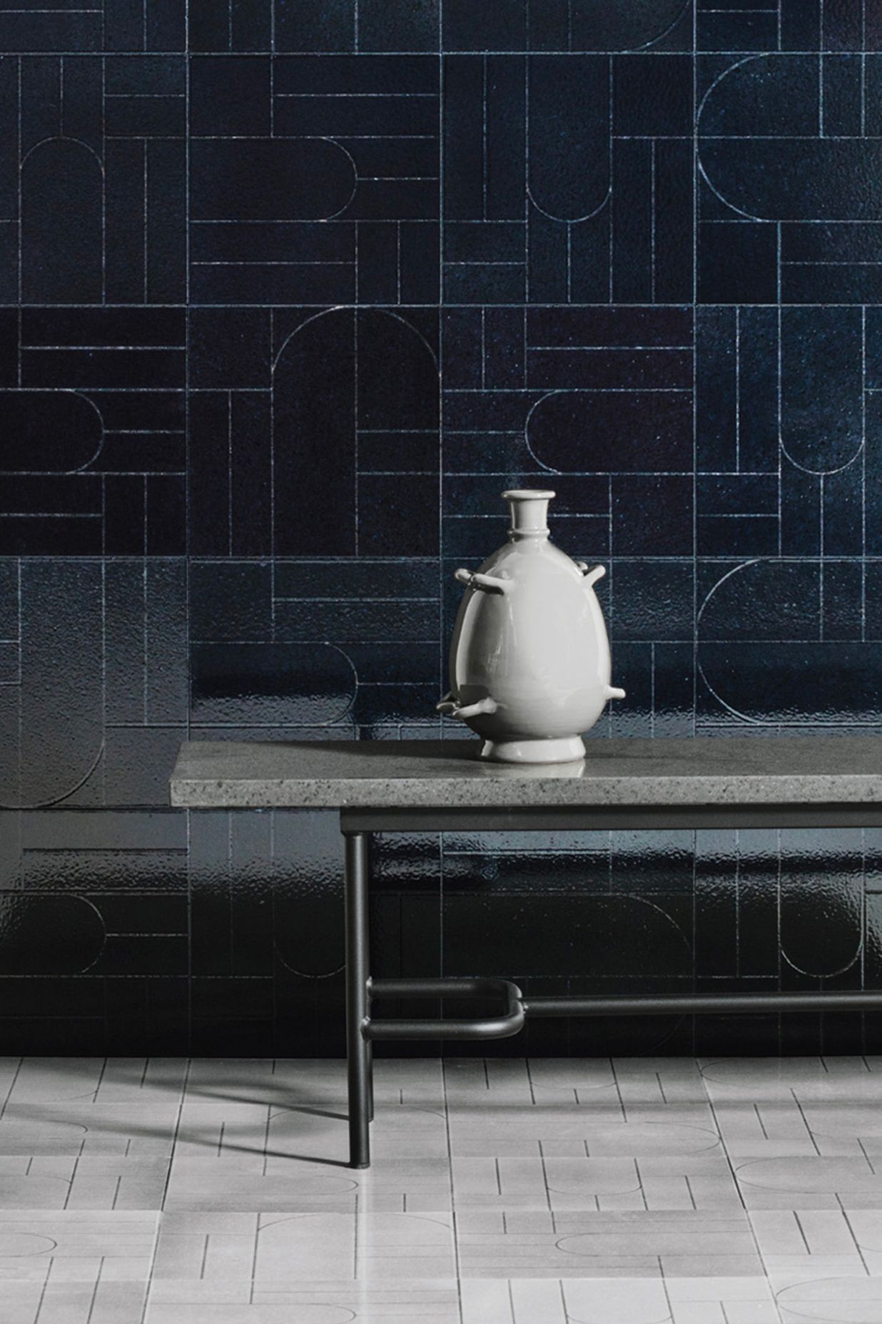 Teorema results from exploring primal symbols made up of minimal, austere signs achieved by incising glazed lava stone tiles.