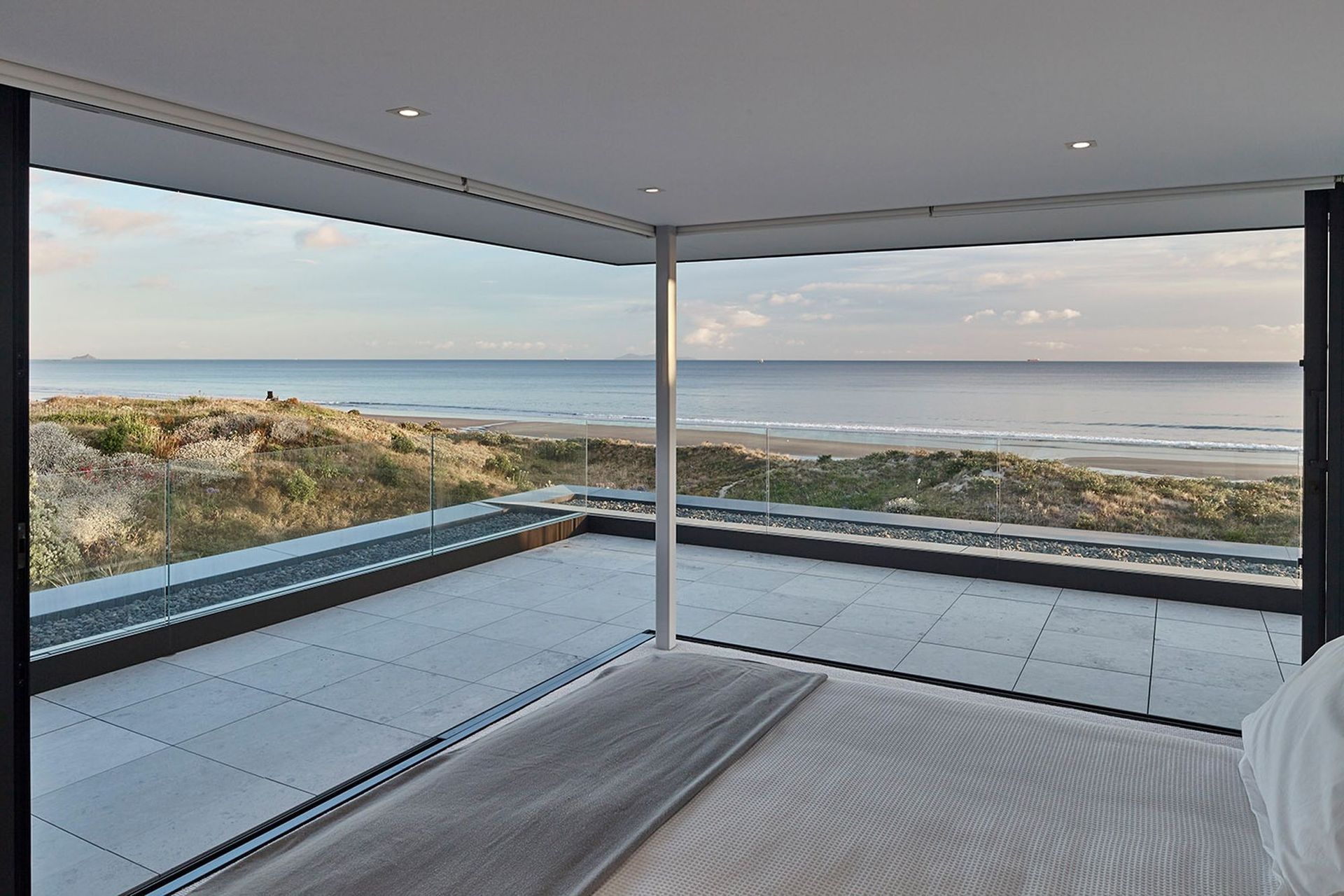 Incorporating spectacular surroundings into the design of your bedroom, seen here in another amazing Mt Maunganui home, enhances its serenity appreciably. | Photography: Matt Quérée