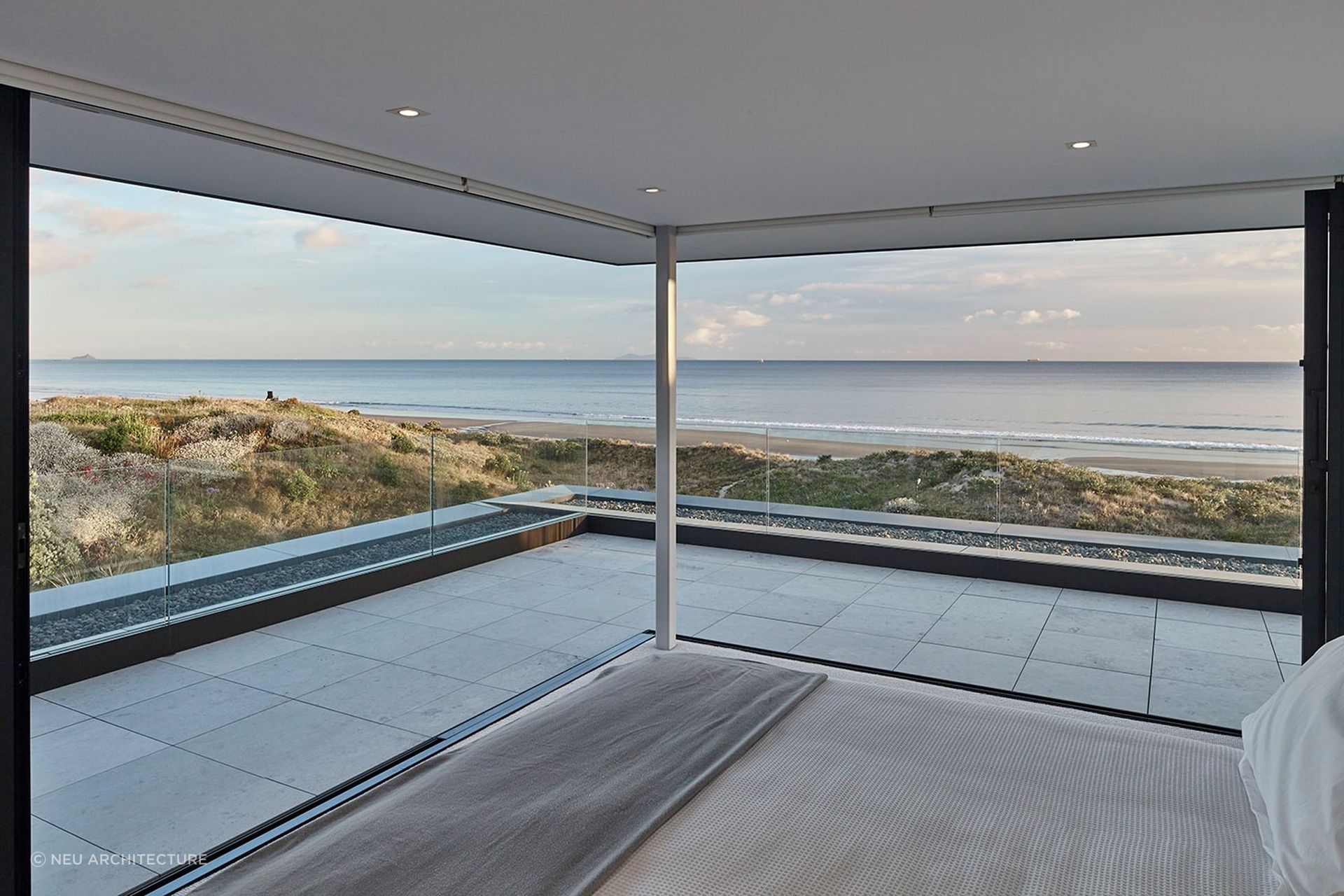 Incorporating spectacular surroundings into the design of your bedroom, seen here in another amazing Mt Maunganui home, enhances its serenity appreciably. | Photography: Matt Quérée