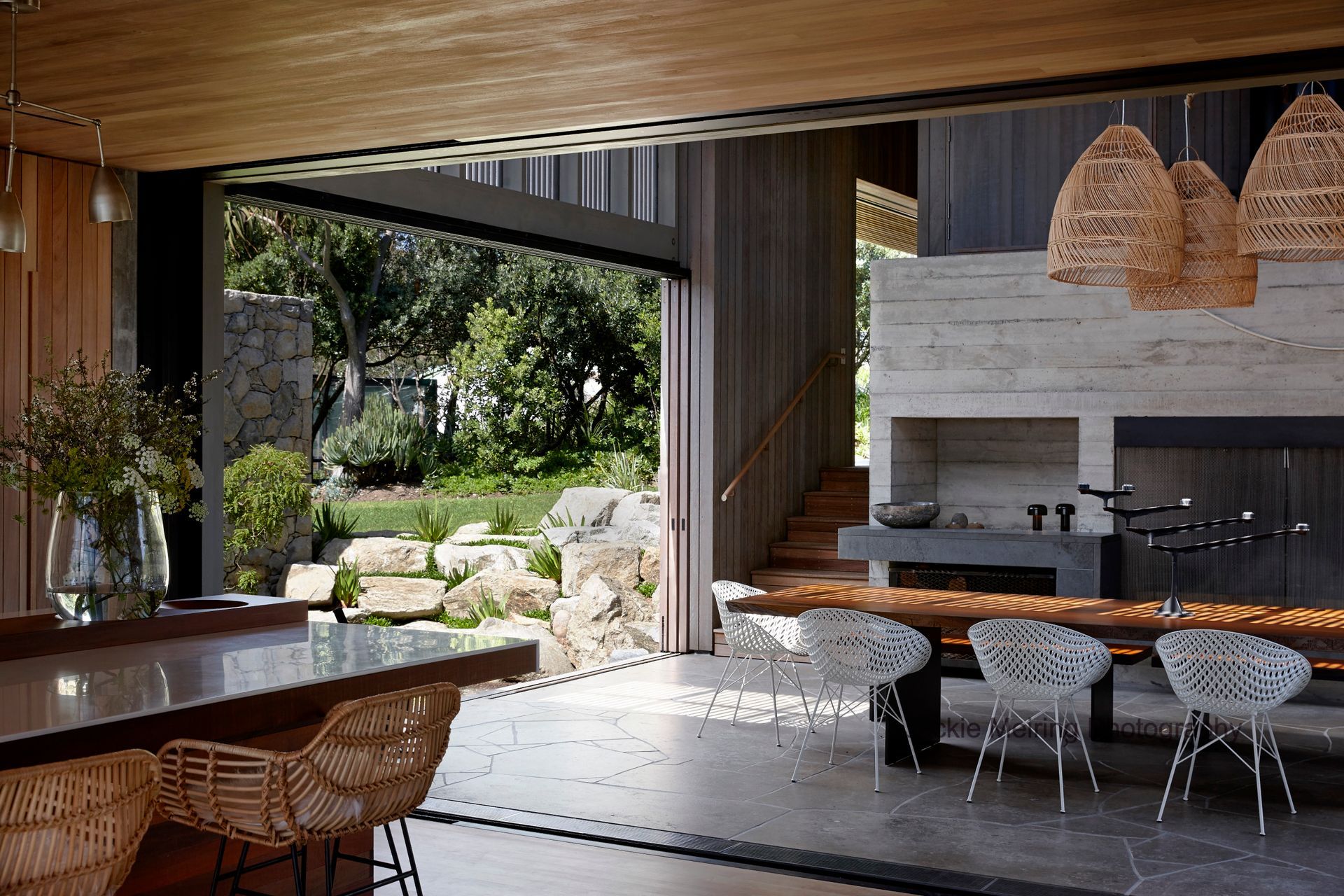 Indoor and outdoor spaces connect in this Awana Bay garden featuring raupo taranga nestled amongst local rock. Photo: Jackie Meiring