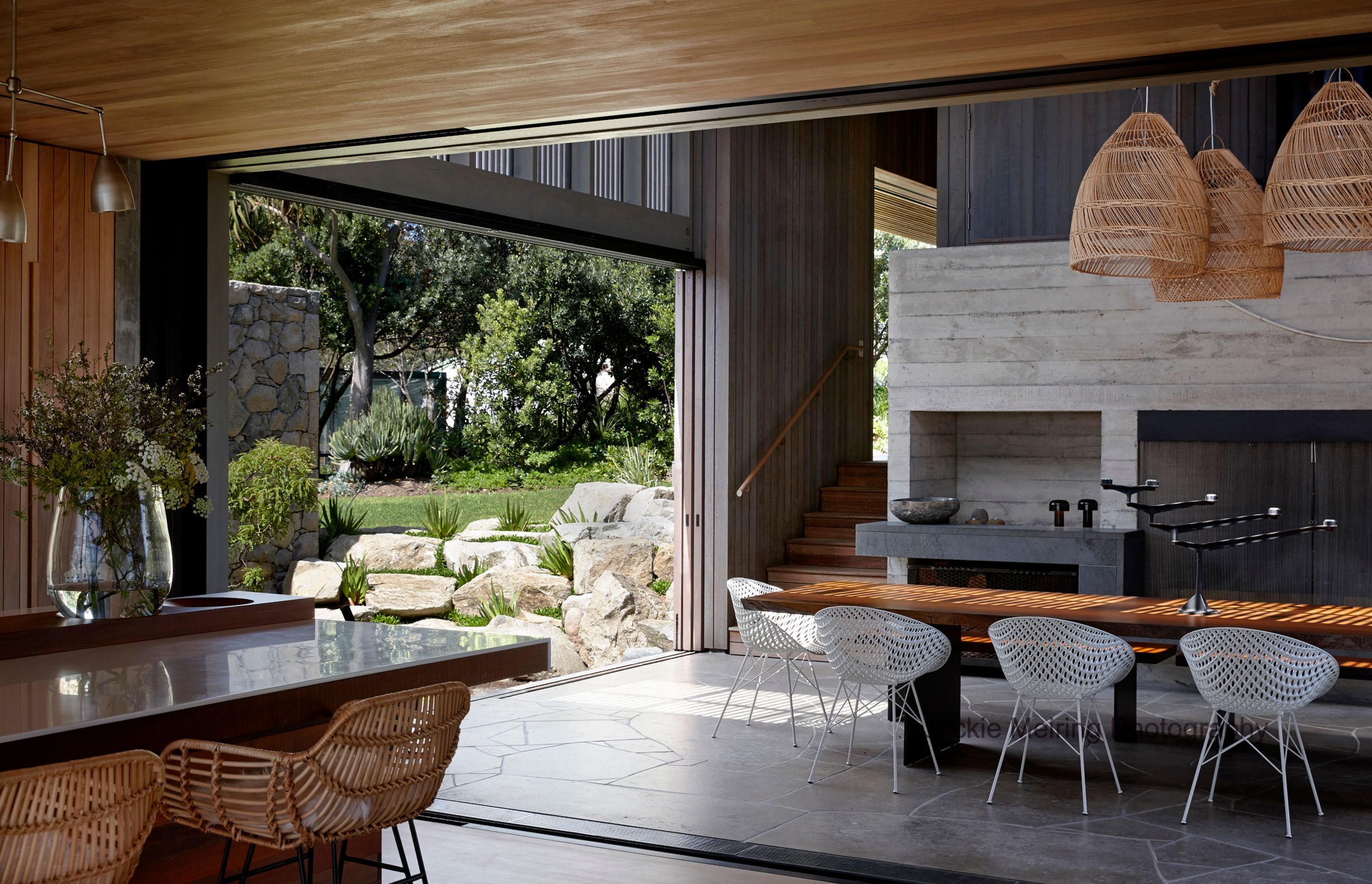 Indoor and outdoor spaces connect in this Awana Bay garden featuring raupo taranga nestled amongst local rock. Photo: Jackie Meiring