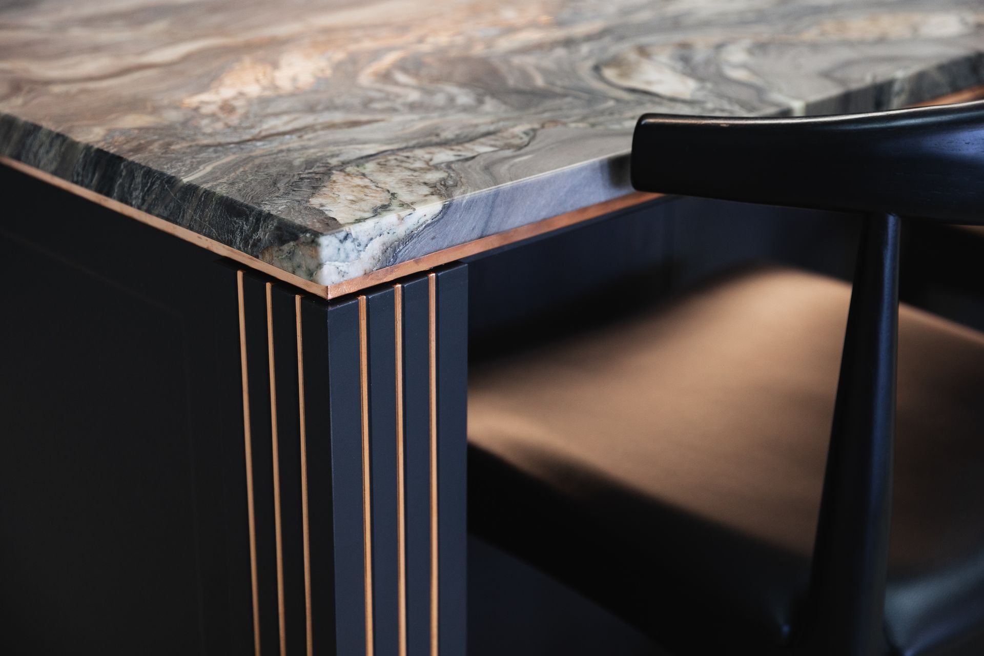 "A live-finish copper detail was introduced to add drama to the material palette; as the copper naturally patinas it will blend with the stone to create an ever-changing kitchen."