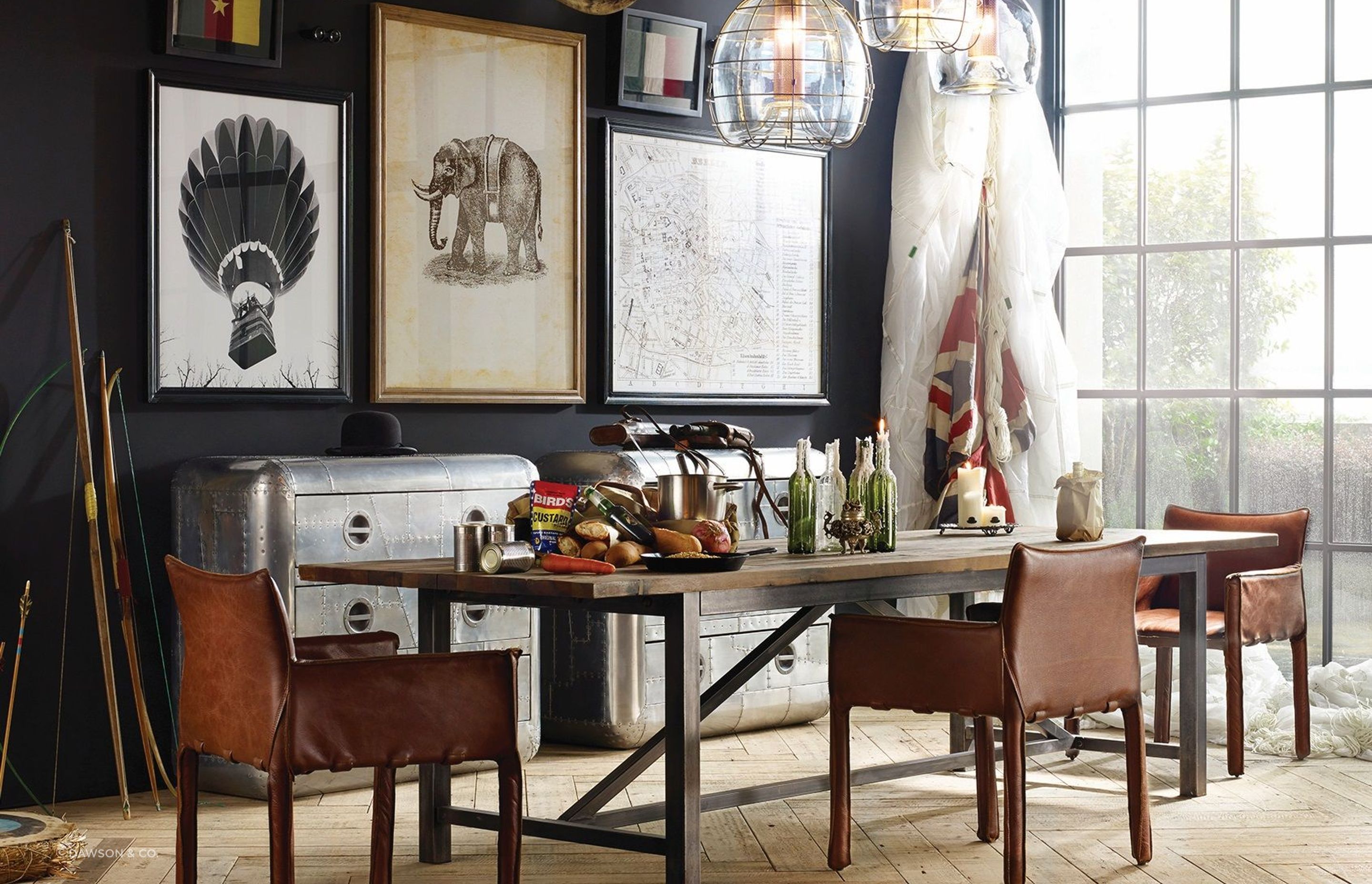 The bold and unique Axel Parquet Dining Table by Timothy Oulton complemented by an eclectic collection of wall art for a dining room full of character.