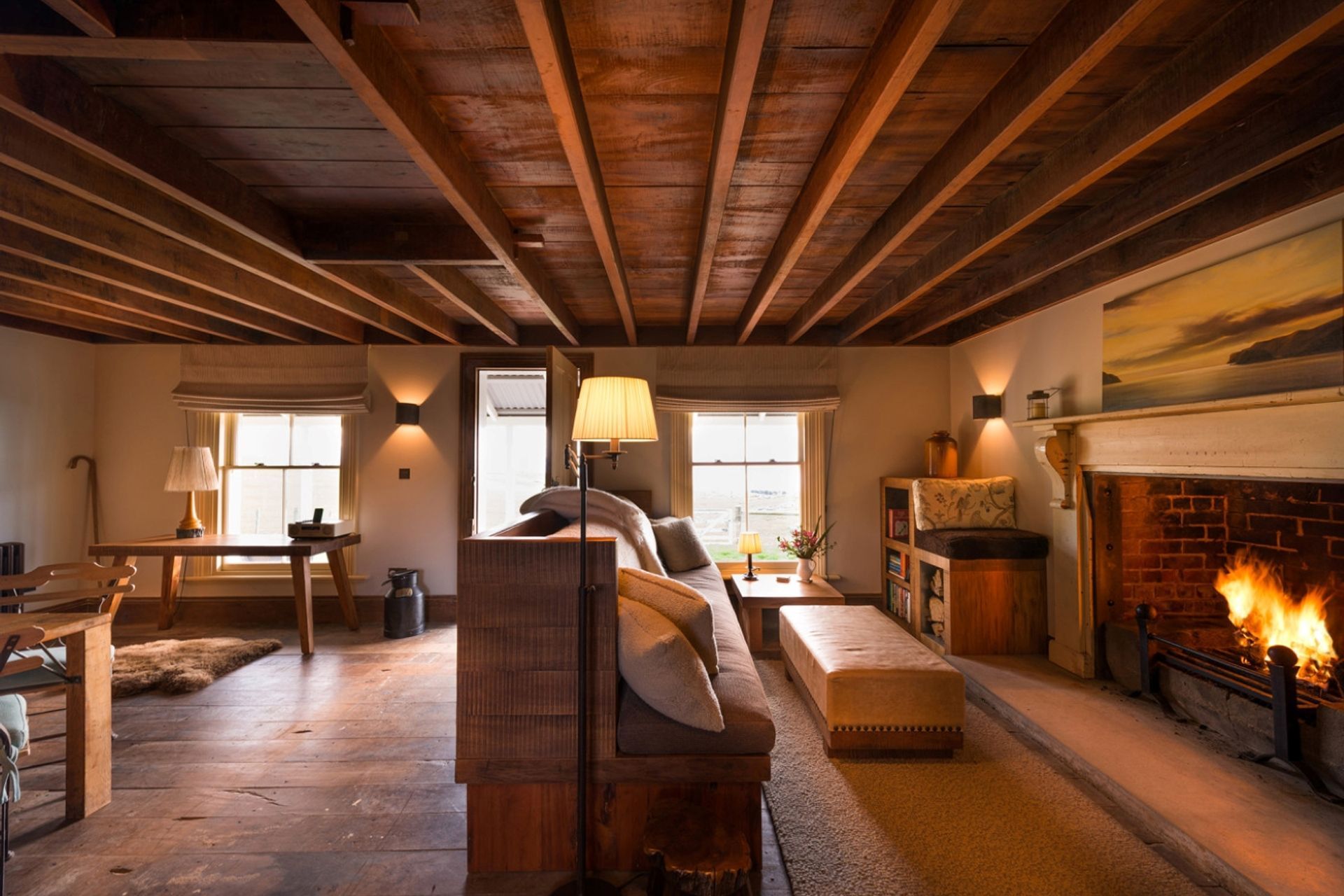 The rich colour of the timber, cosy furnishings and roaring fire fill the cottage with warmth.