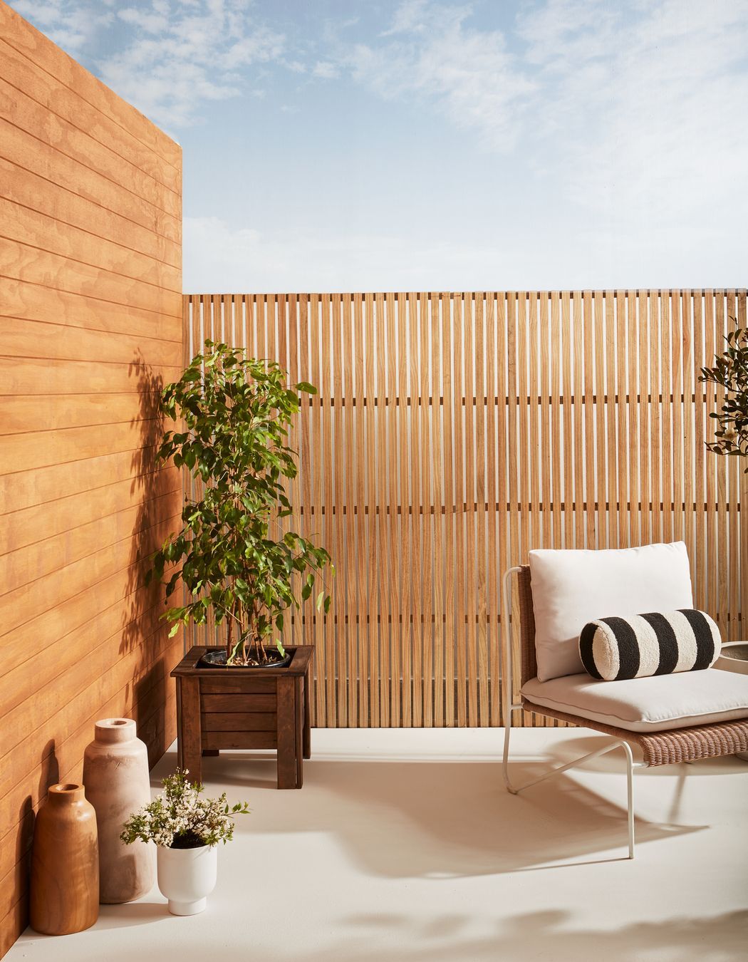 Weatherboards finished in Resene Natural Wood Oil in Resene Egmont. Trellis finished in Resene Natural Wood Oil in Resene Aorangi.