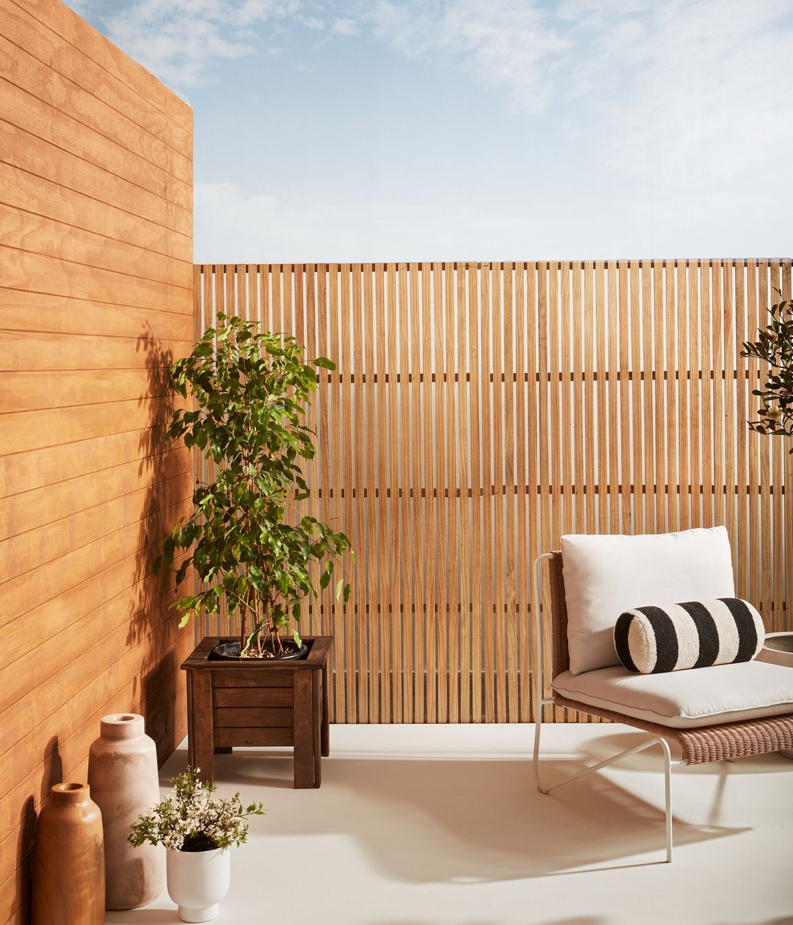 Weatherboards finished in Resene Natural Wood Oil in Resene Egmont. Trellis finished in Resene Natural Wood Oil in Resene Aorangi.