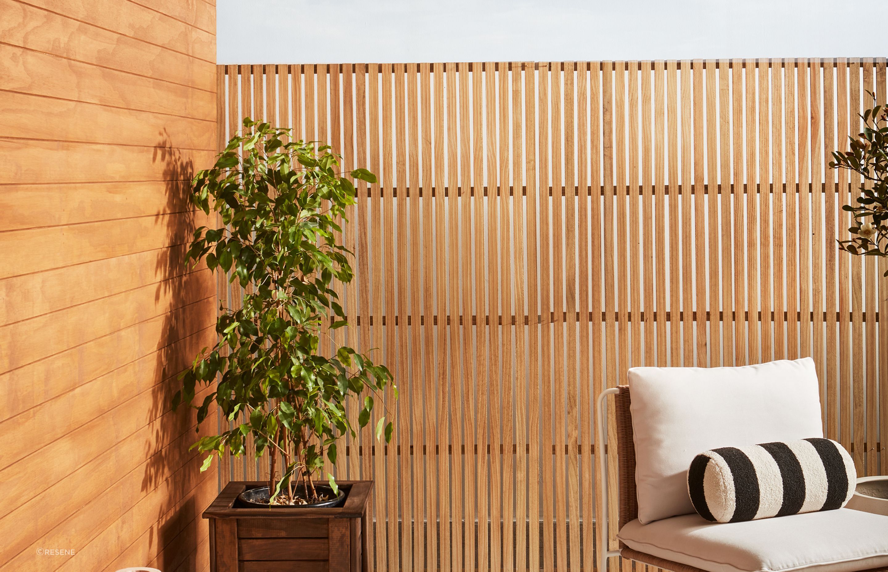  Weatherboards finished in Resene Natural Wood Oil in Resene Egmont. Trellis finished in Resene Natural Wood Oil in Resene Aorangi.