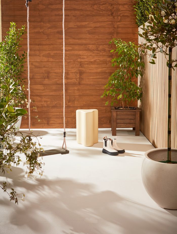 Weatherboards finished in Resene Natural Wood Oil in Resene Egmont. Trellis finished in Resene Natural Wood Oil in Resene Aorangi. Floor in Resene Walk-on in Resene Merino.