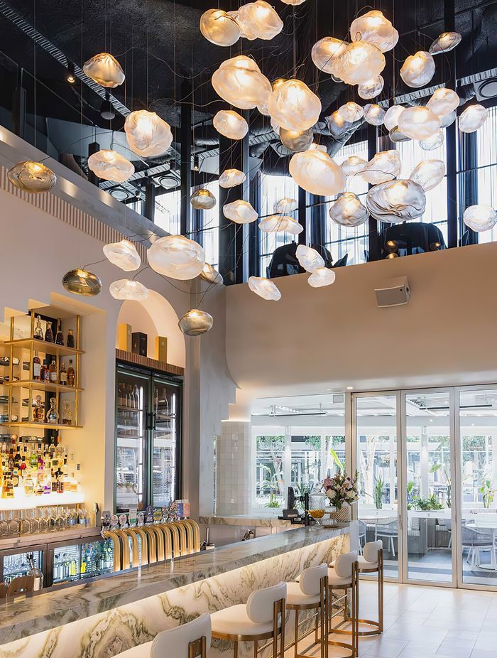 The largest Bocci commission in Australia to date, the cluster of 61 hand-blown Bocci 73 Series glass lights transform the Blowfish Ocean Grill + Bar on the Gold Coast designed by Space Cubed Design Studio. Photography by Harley McNamee courtesy of Bocci