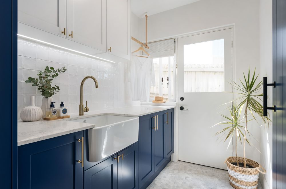 Plenty of windows that drench this laundry with light ensure it'll never develop a damp problem. Shaker Laundry Project by Castella Architectural Hardware | Photography by Just In Place
