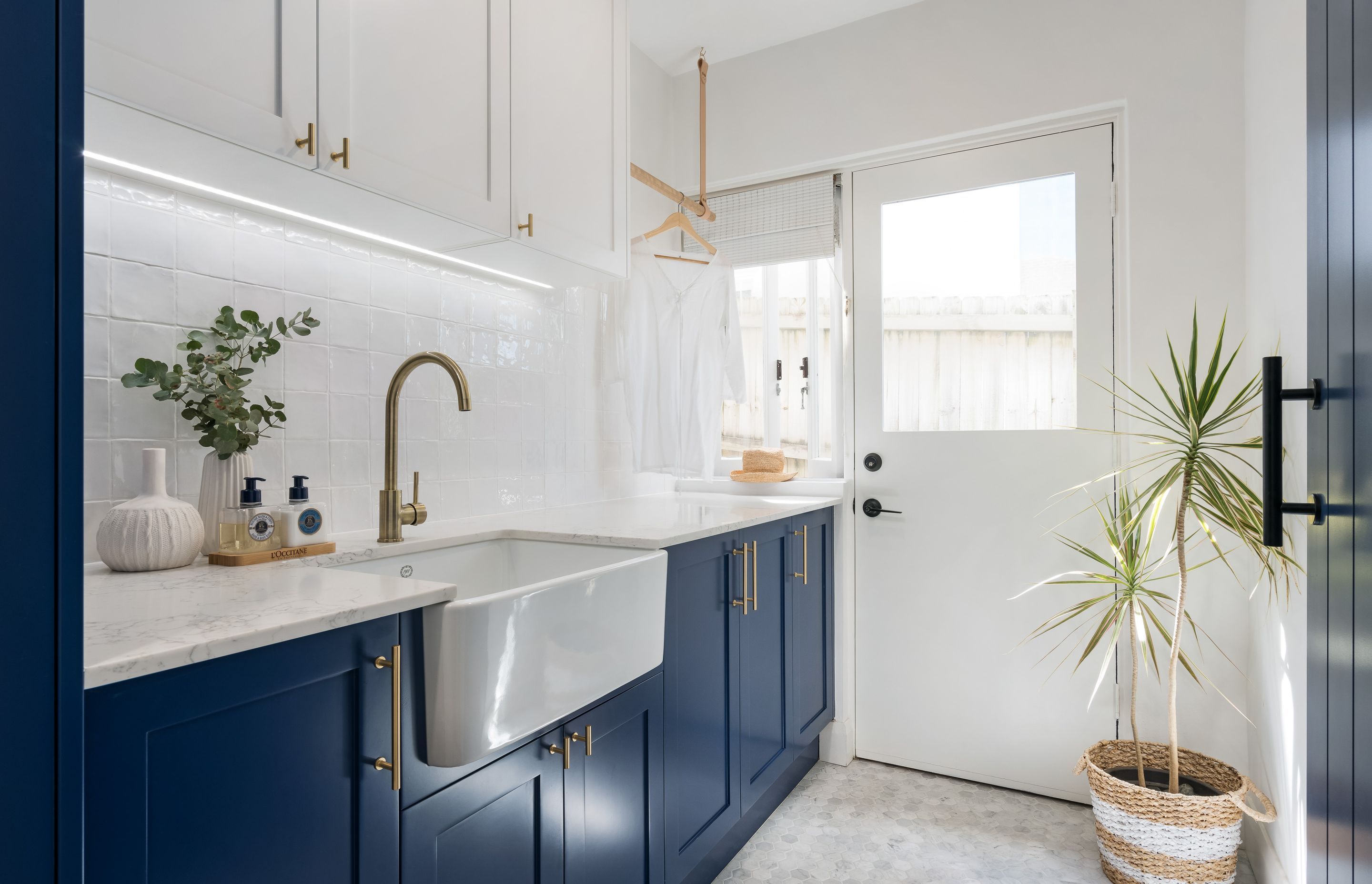 Plenty of windows that drench this laundry with light ensure it'll never develop a damp problem. Shaker Laundry Project by Castella Architectural Hardware | Photography by Just In Place