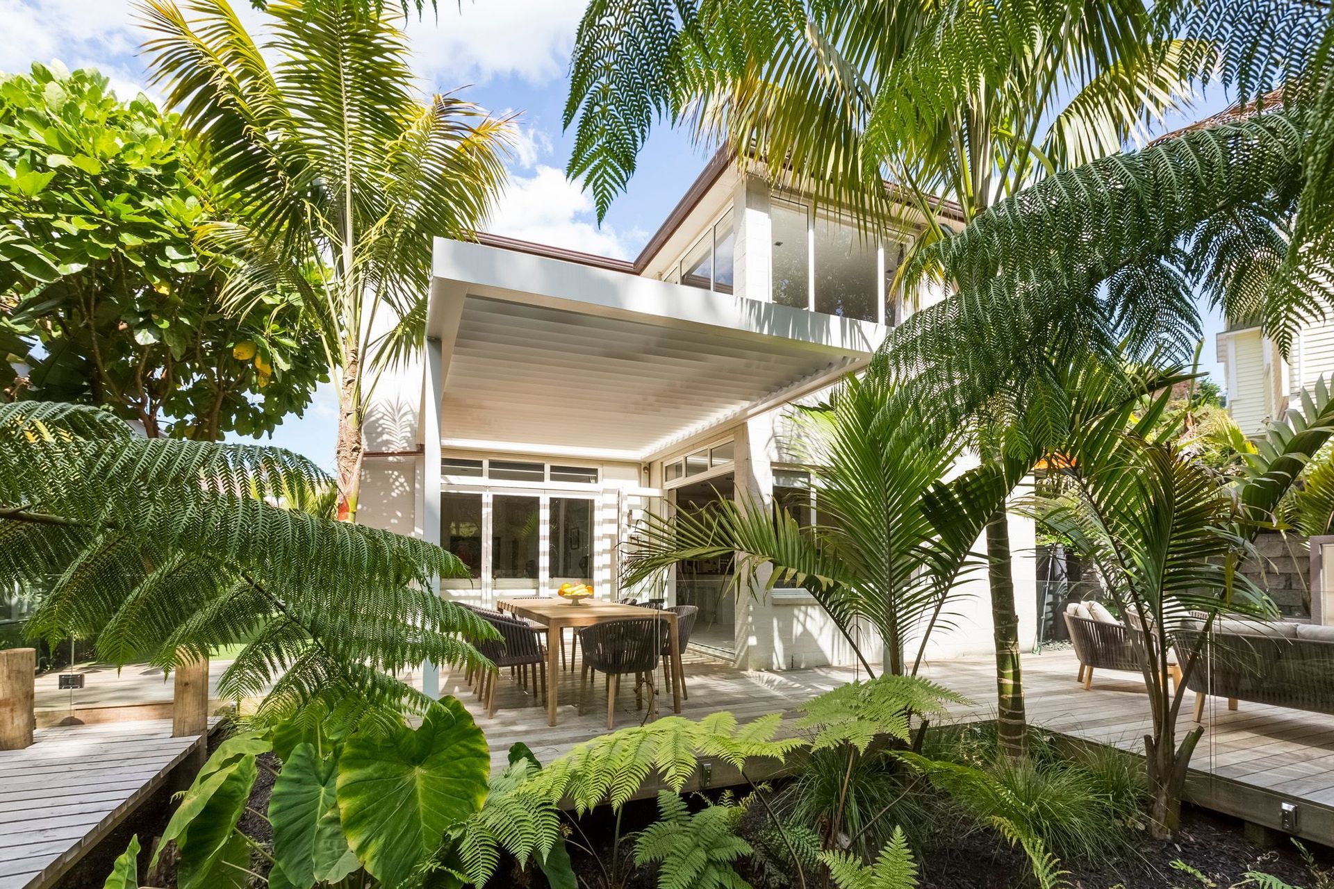 An exotic ambience that transports you away, helped by some tropical plants in this Remuera home.