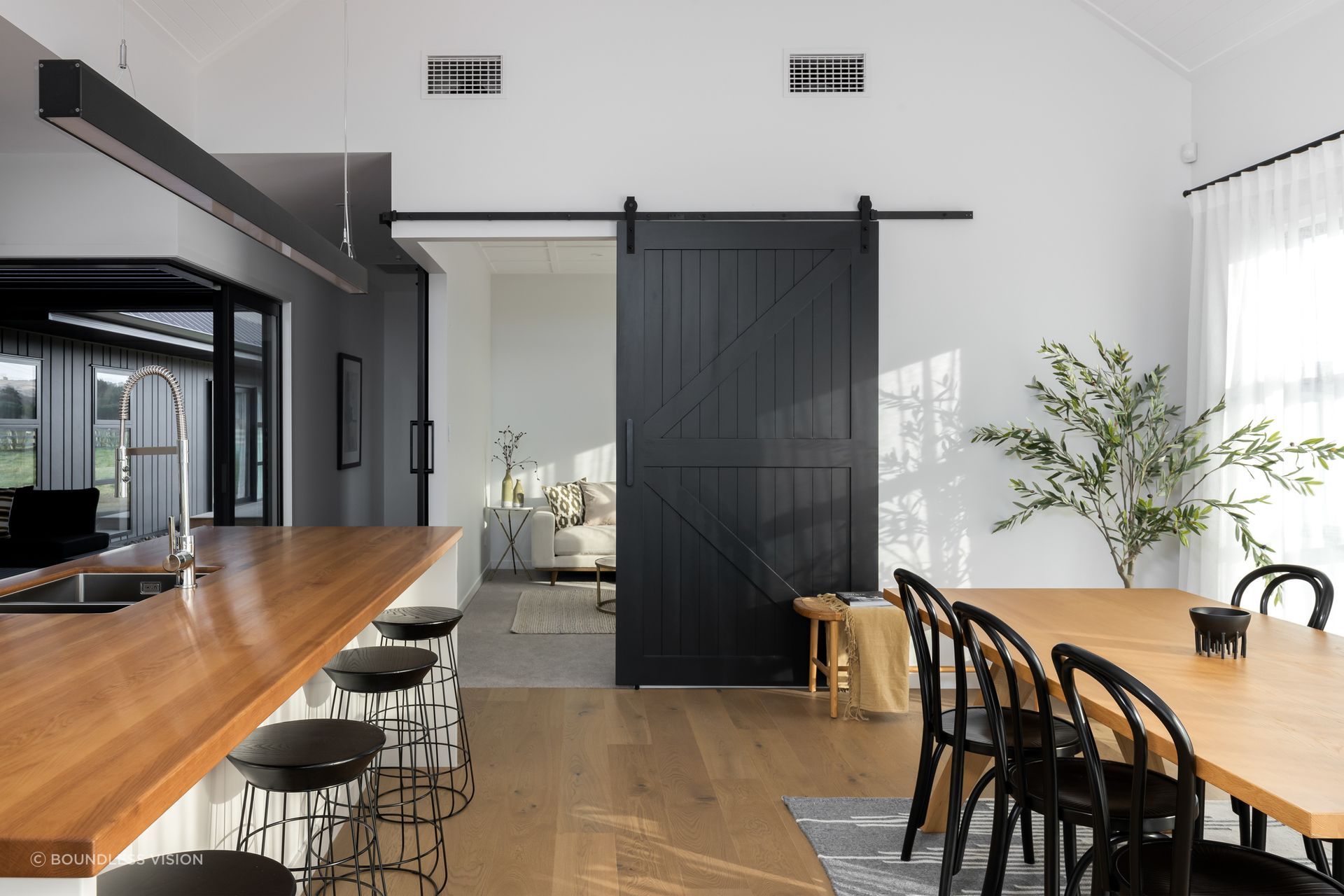 Cleverly placed barn-style doors separate or connect spaces on demand. 