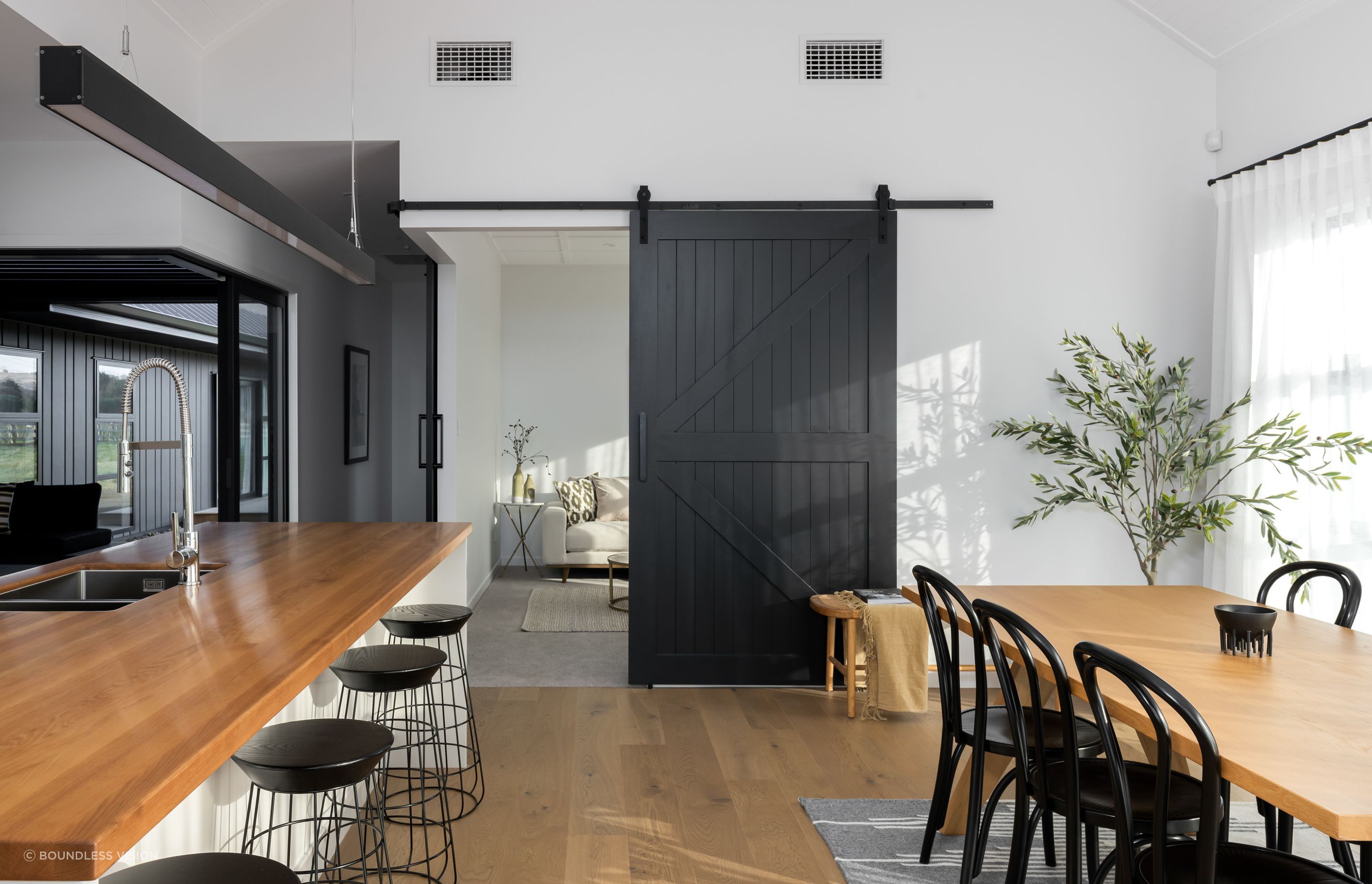 Cleverly placed barn-style doors separate or connect spaces on demand.