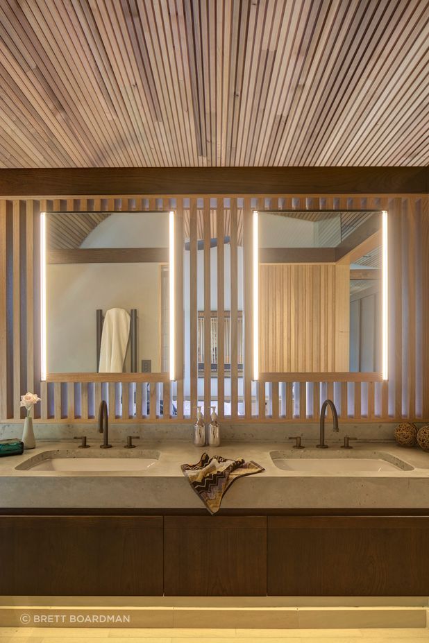 The face-level bathroom lighting mimics the timber battens.