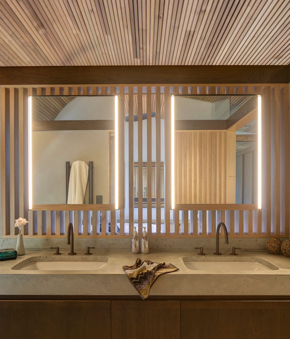 The face-level bathroom lighting mimics the timber battens.