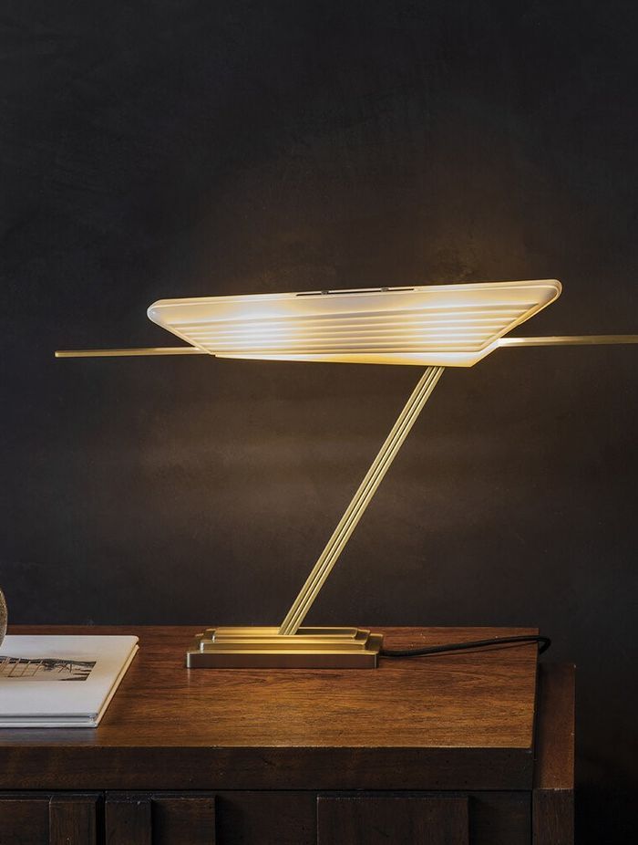 Exquisite materials that include a bone fine china shade and brass base with the Glaive Table Lamp