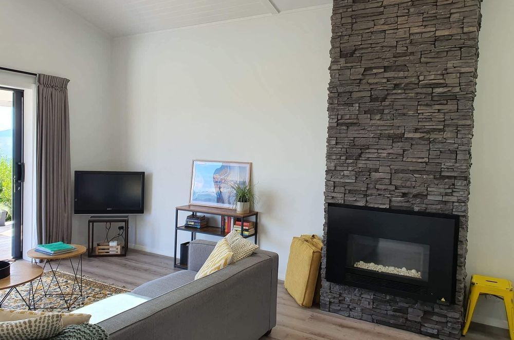 A schist stone fireplace adds a ‘wow-factor’ to the space.