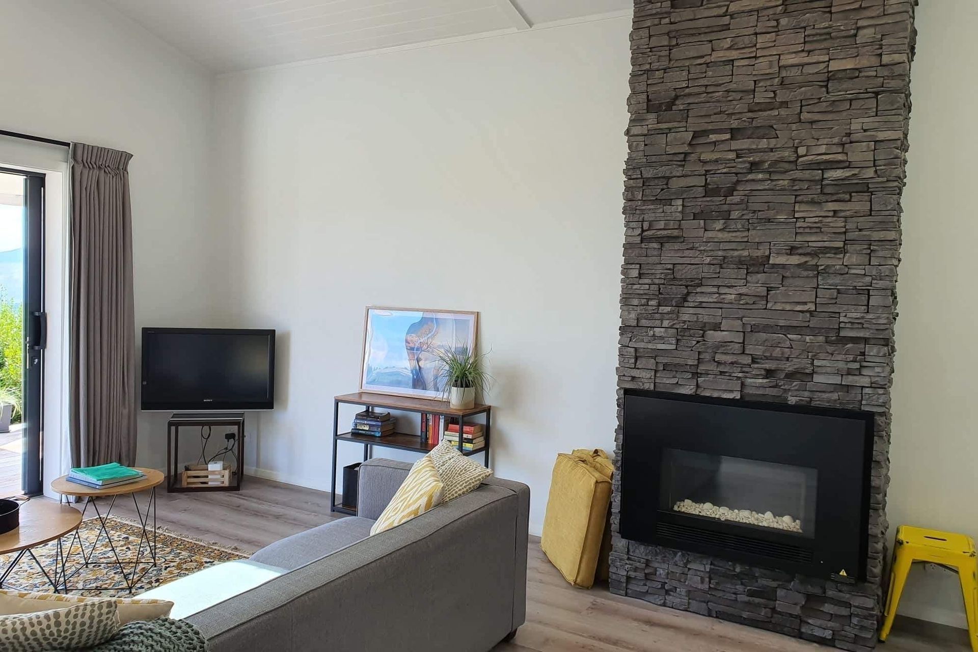 A schist stone fireplace adds a ‘wow-factor’ to the space.