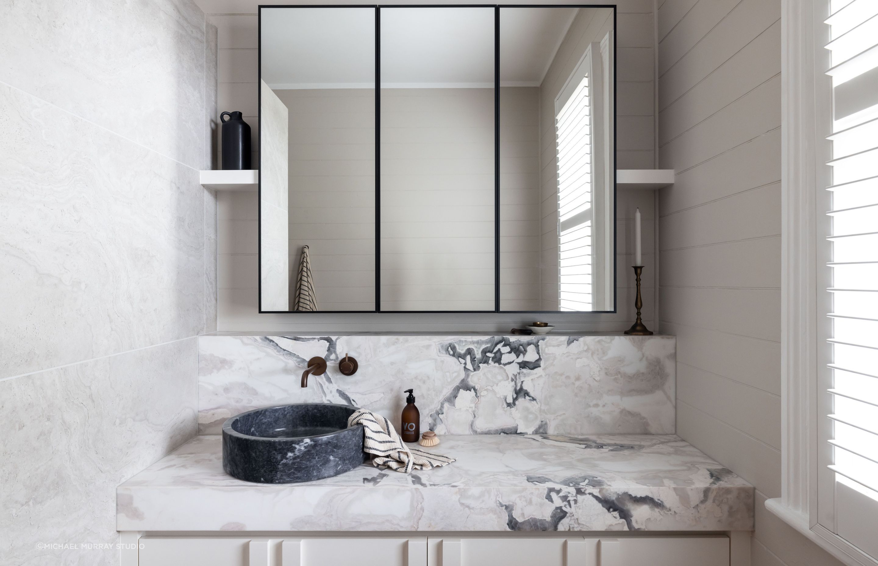 The blue stone basin and marble vanity top in this bathroom in Puriri shows the difference high-quality materials can make - Photography: Jono Parker