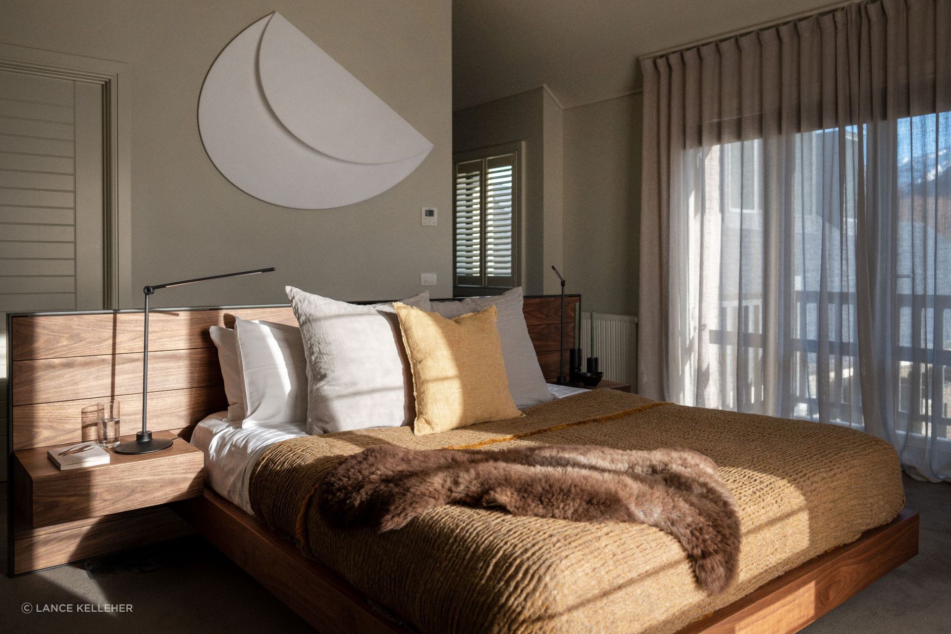 Combining textures, like the natural hardwood bed frame and soft bedding of this gorgeous South Island home, adds warmth and visual interest to a bedroom.