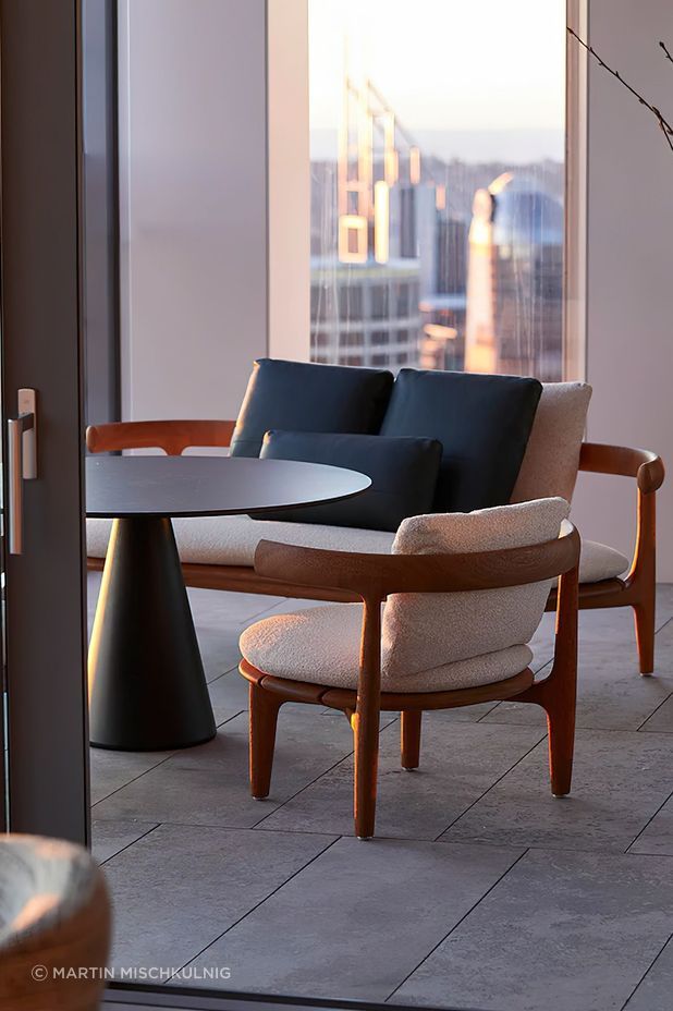 The Jove coffee table designed by Draga and Aurel, with the Himba Little Armchair and Sofa by Roberto Lazzeroni, both by Baxter. Photo © Martin Mischkulnig