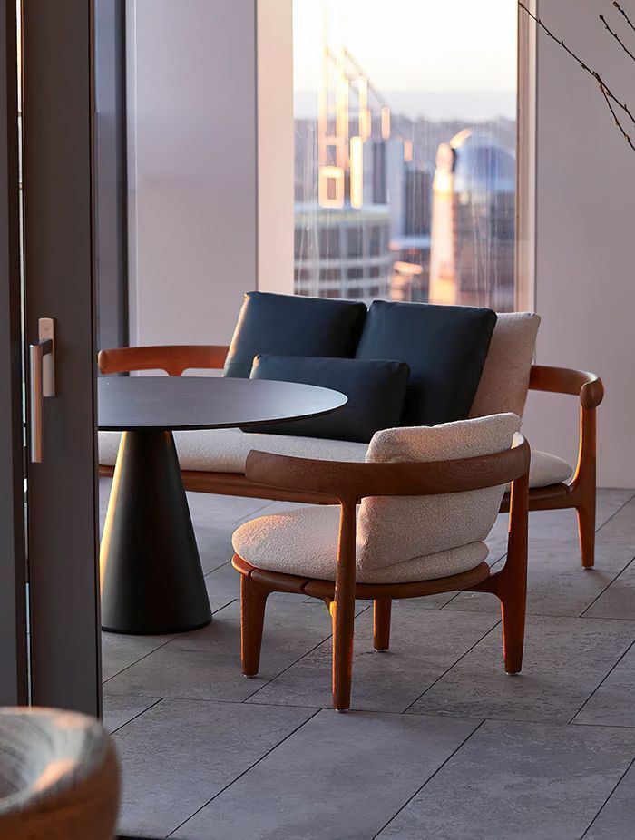 The Jove coffee table designed by Draga and Aurel, with the Himba Little Armchair and Sofa by Roberto Lazzeroni, both by Baxter. Photo © Martin Mischkulnig