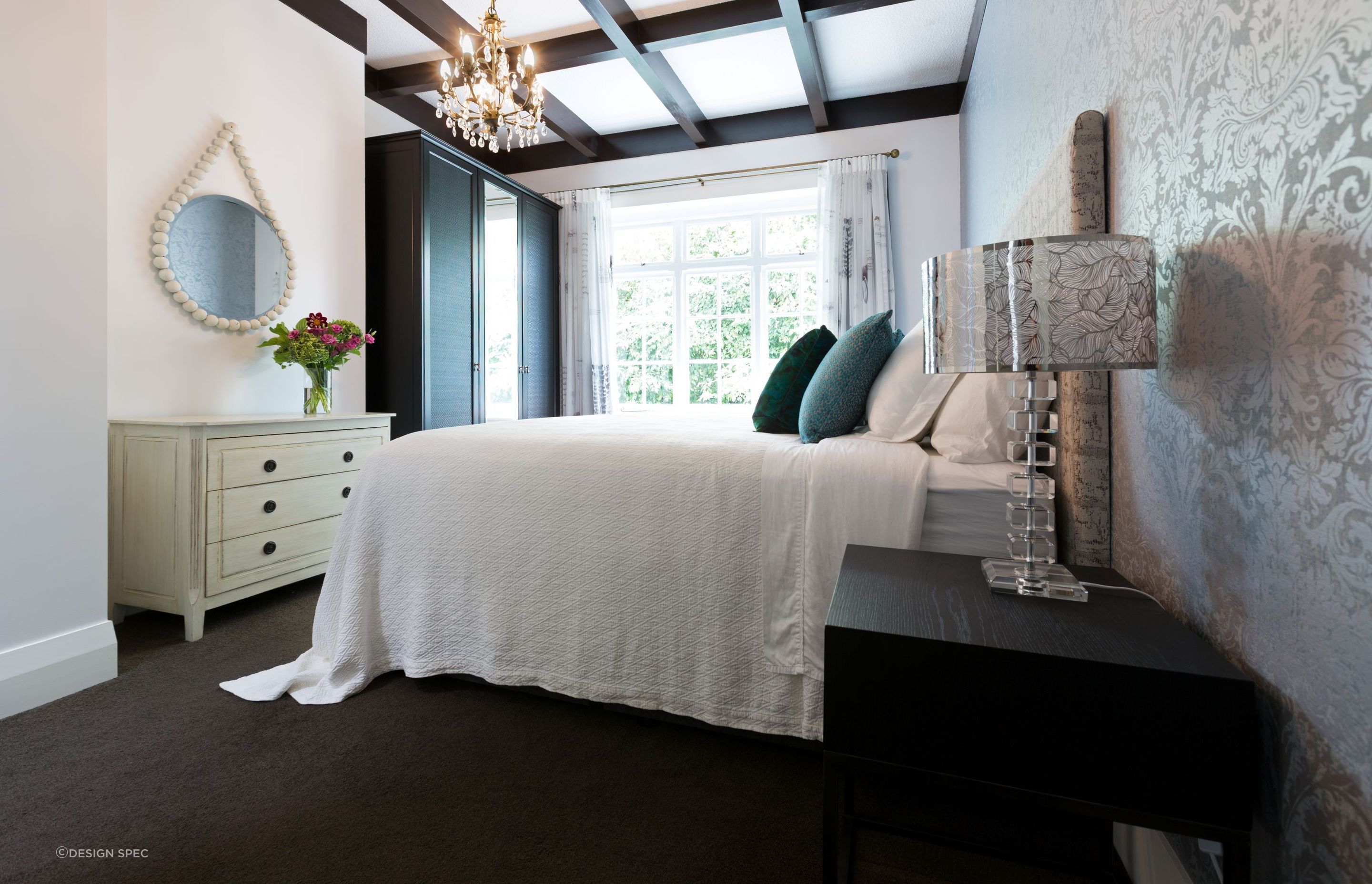 Warm toned bulbs, like those in the exquisite chandelier in this Pukenui Road residence, combine well with natural light to bring comfort to a space.