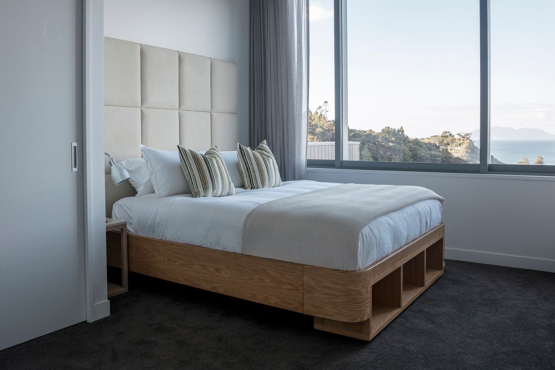This Sarsfield Brooke custom bed was locally made for the Matakana home. Offering a design and make service to include headboards, beds, wooden furniture pieces and rugs.