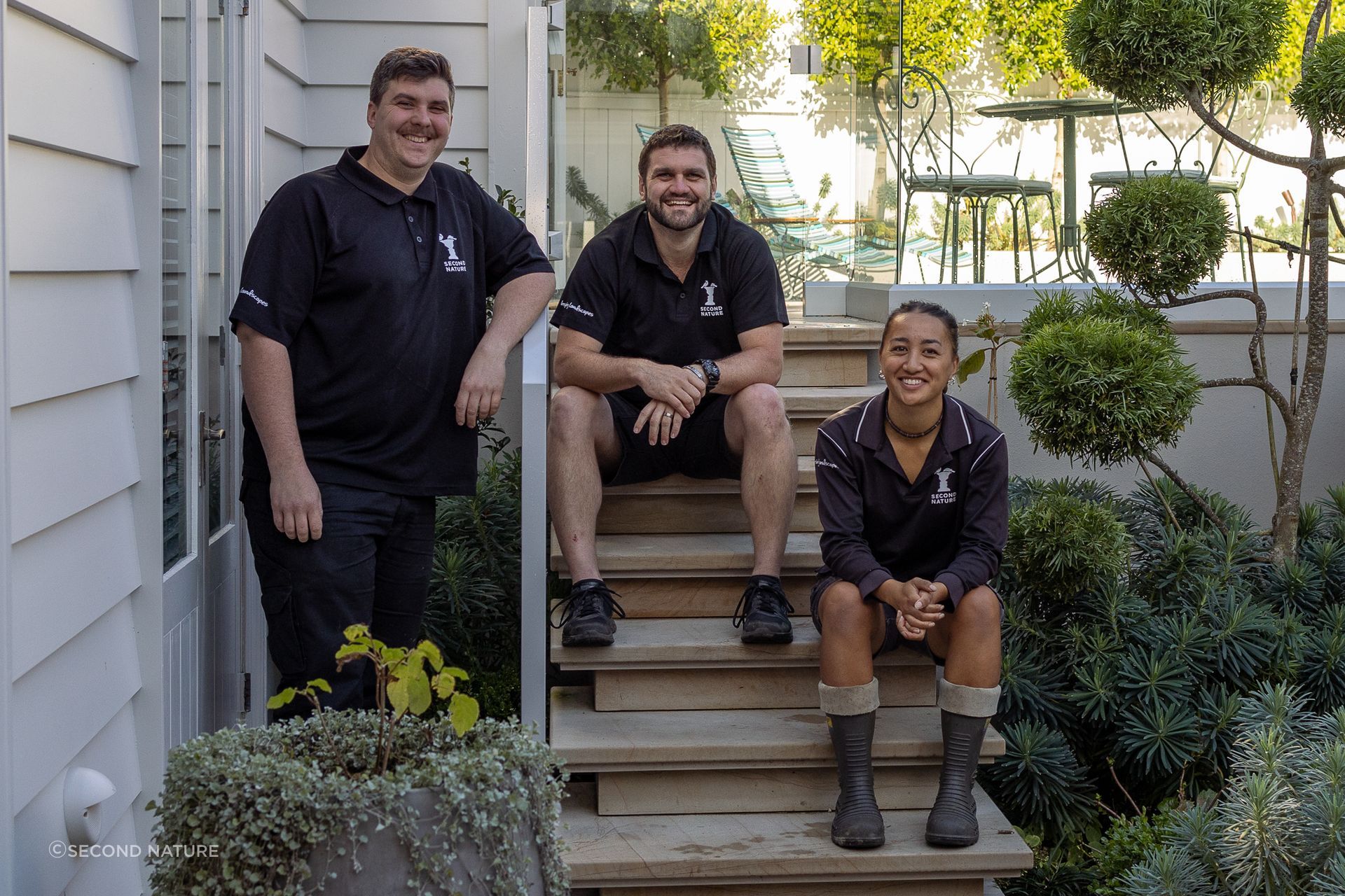Second Nature team members pictured among the flourishing foliage of a completed project.