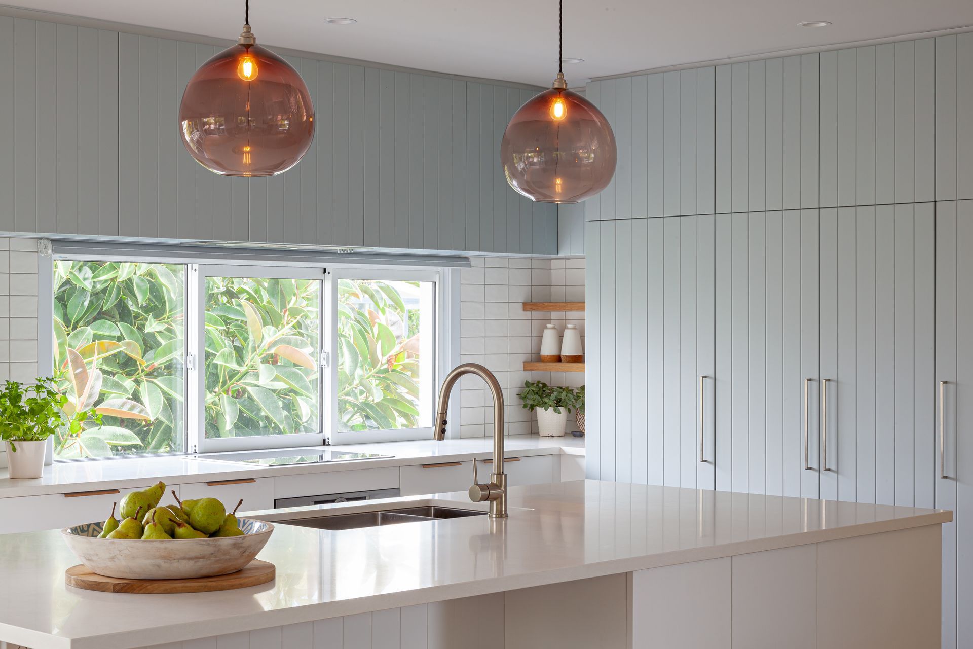 The tongue and groove Kawhia profile (shown here in Villa Blue) works everywhere from coastal home to classic villa. Design by Michelle McAnulty, Beaver Kitchens.