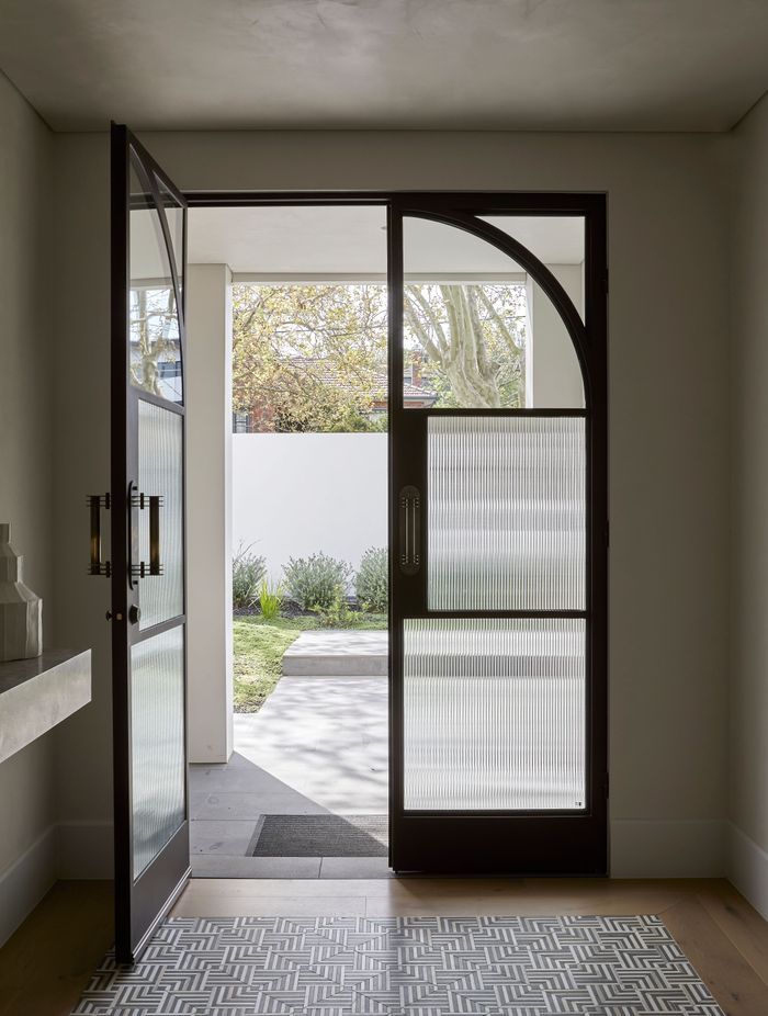 Square steel mullions were incorporated on the entry doors to complement the hallway archway.