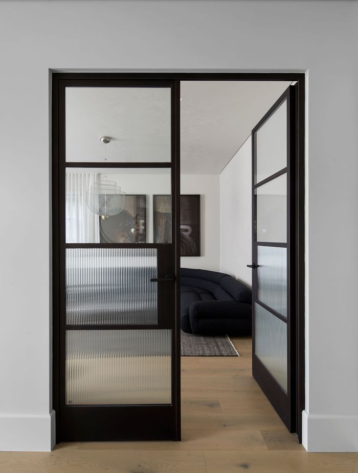 The black steel frame doors bring a modern touch to the Art Deco-inspired home.