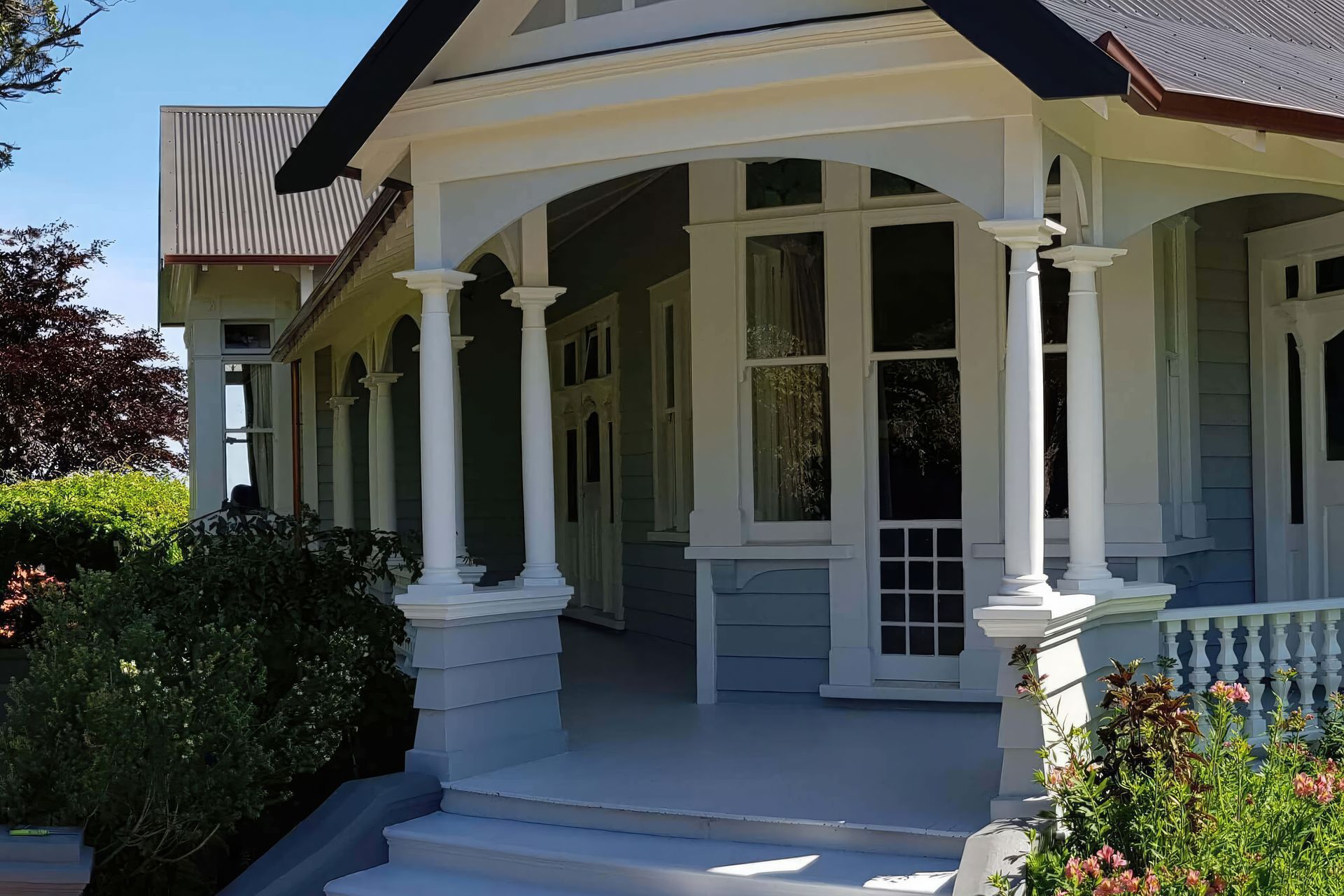 The façade of the villa, contrasting the modern aesthetic of the extension.