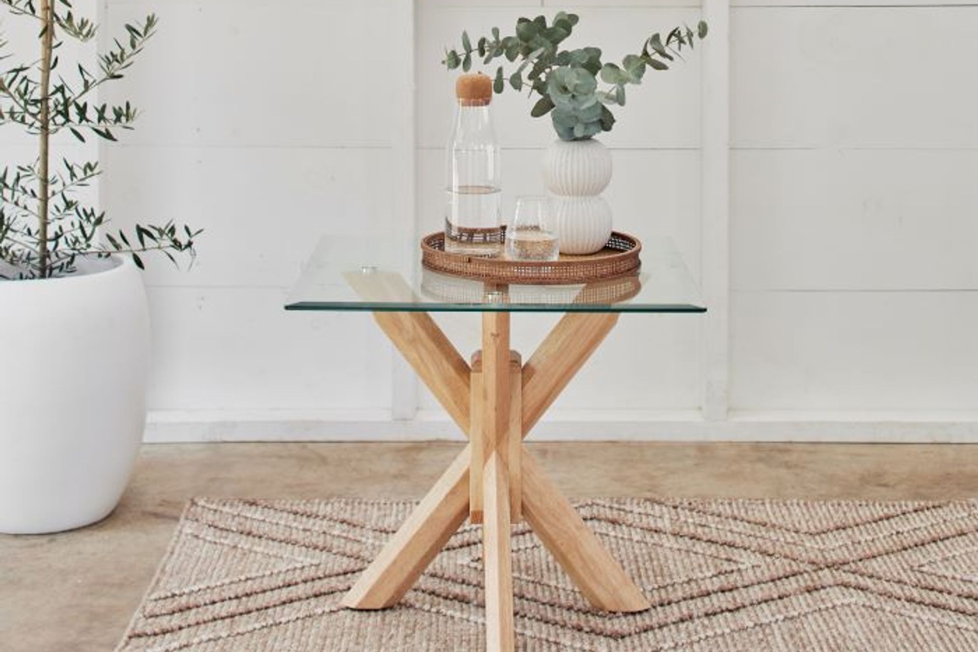 Glass-topped bedside tables, like the Bella Glass Lamp Table, show off trendy design and charm.