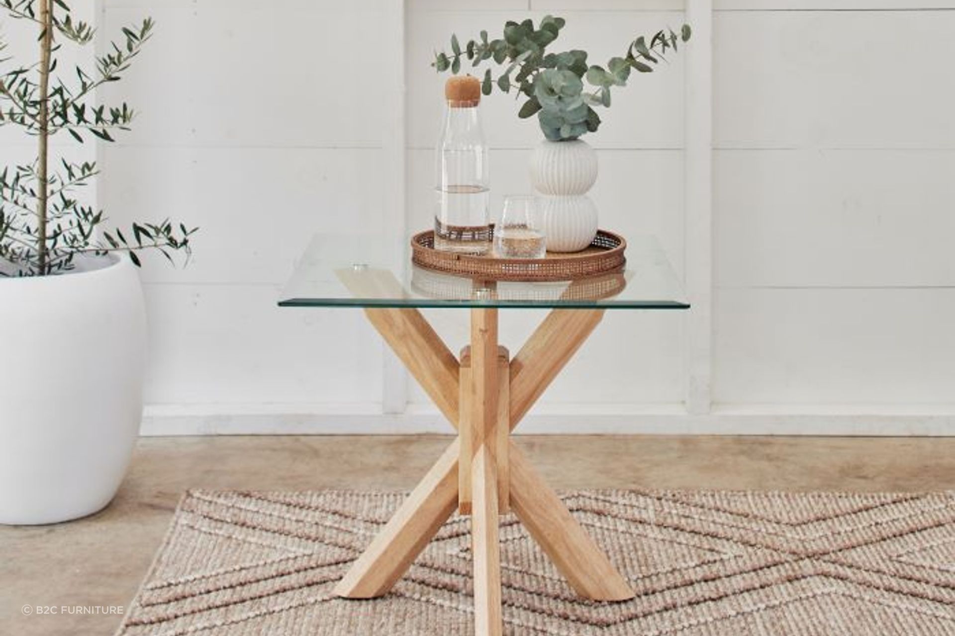 Glass-topped bedside tables, like the Bella Glass Lamp Table, show off trendy design and charm.