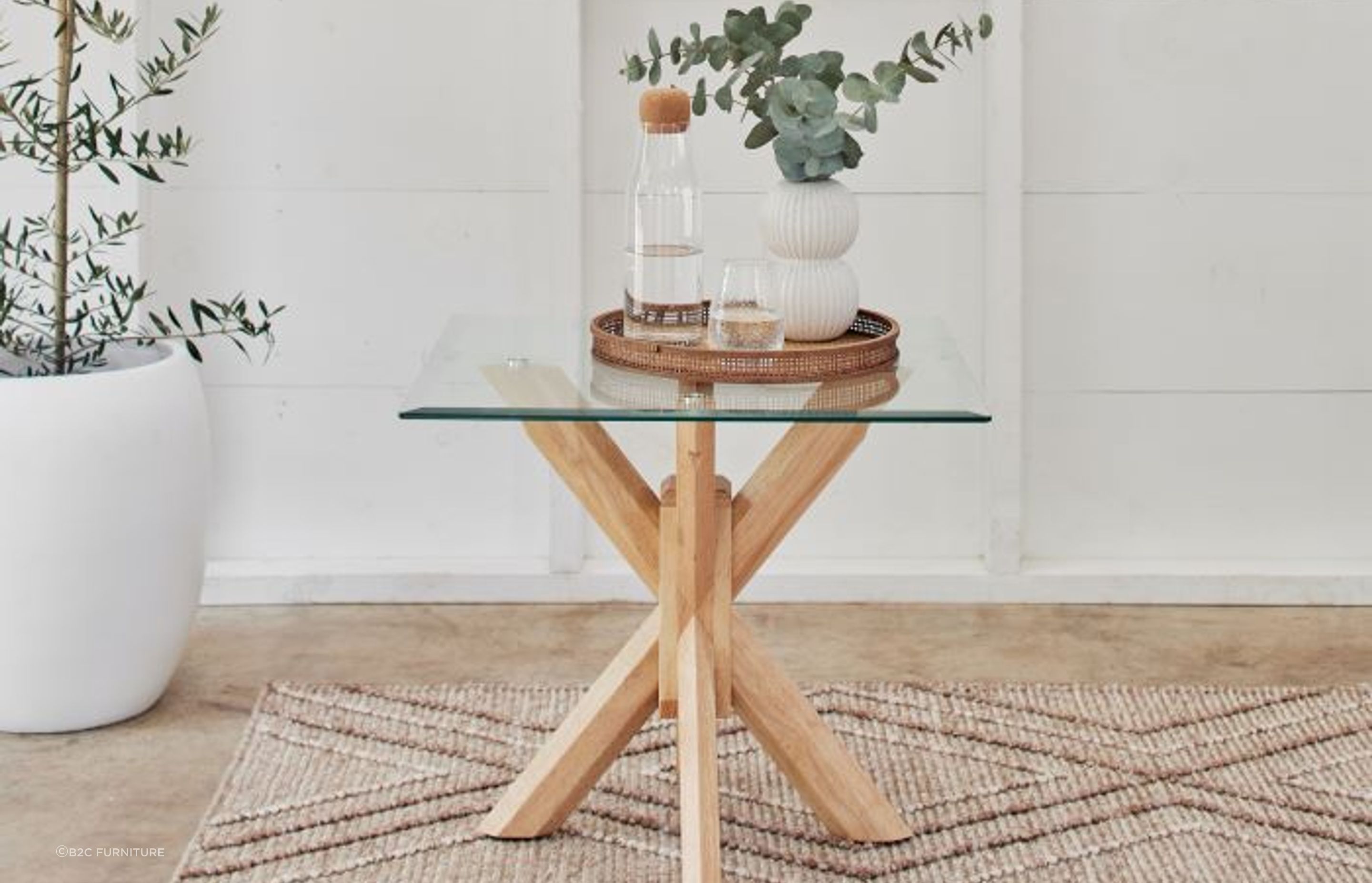 Glass-topped bedside tables, like the Bella Glass Lamp Table, show off trendy design and charm.