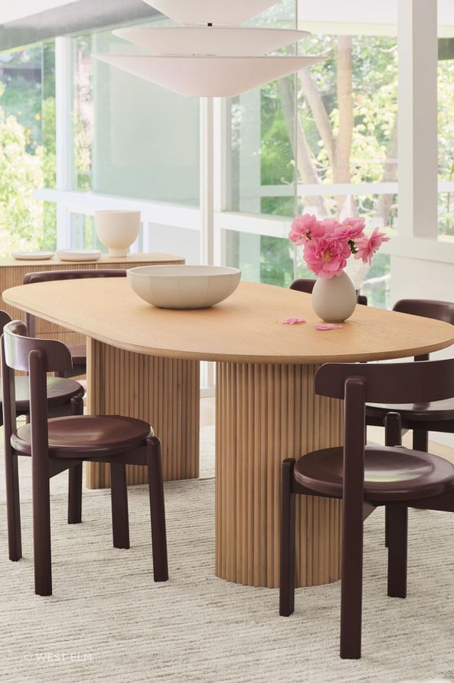 The solid wood Bryant Dining Chair's minimal silhouette leans into a vintage aesthetic.