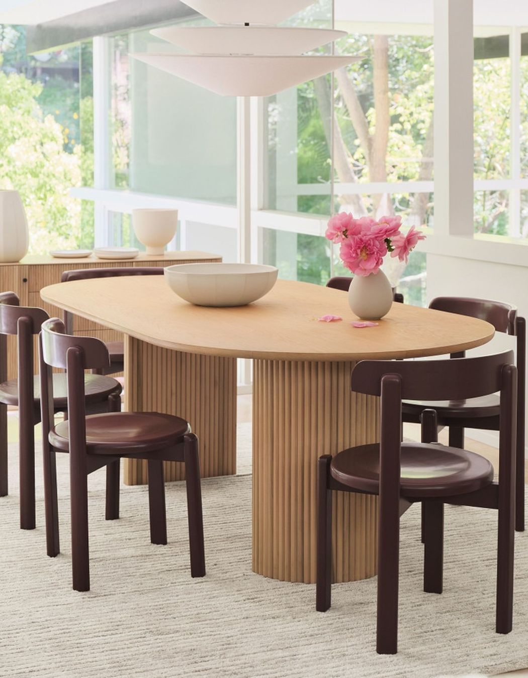 The solid wood Bryant Dining Chair's minimal silhouette leans into a vintage aesthetic.