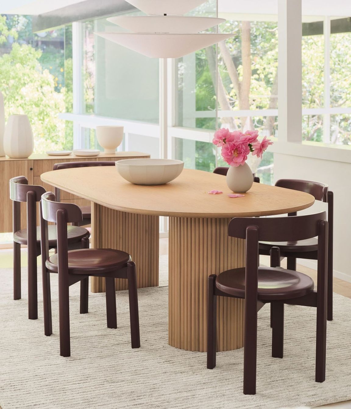The solid wood Bryant Dining Chair's minimal silhouette leans into a vintage aesthetic.
