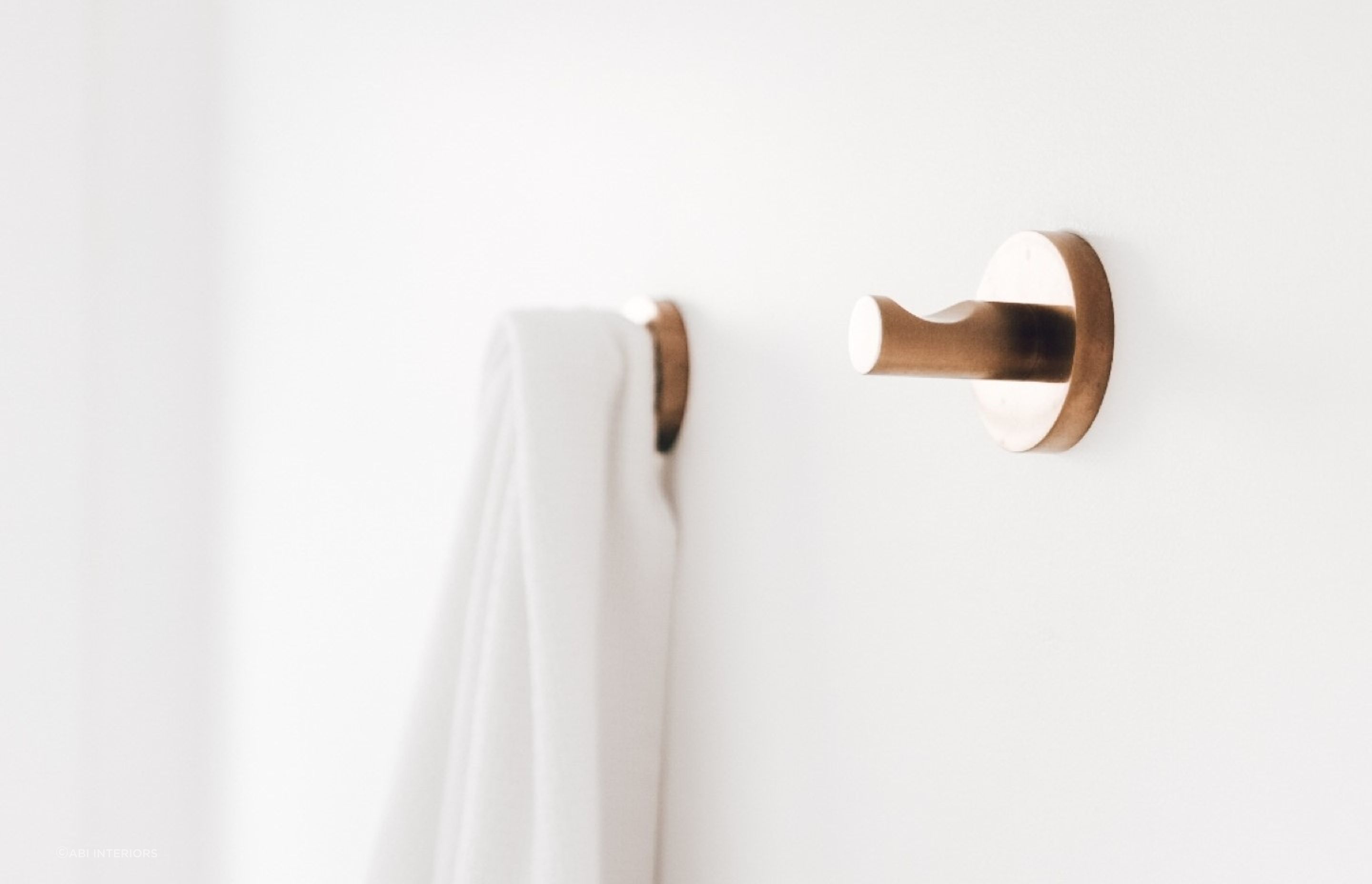 The Elysian Robe Hook in brushed copper offers a sophisticated solution for hanging your robes and towels.