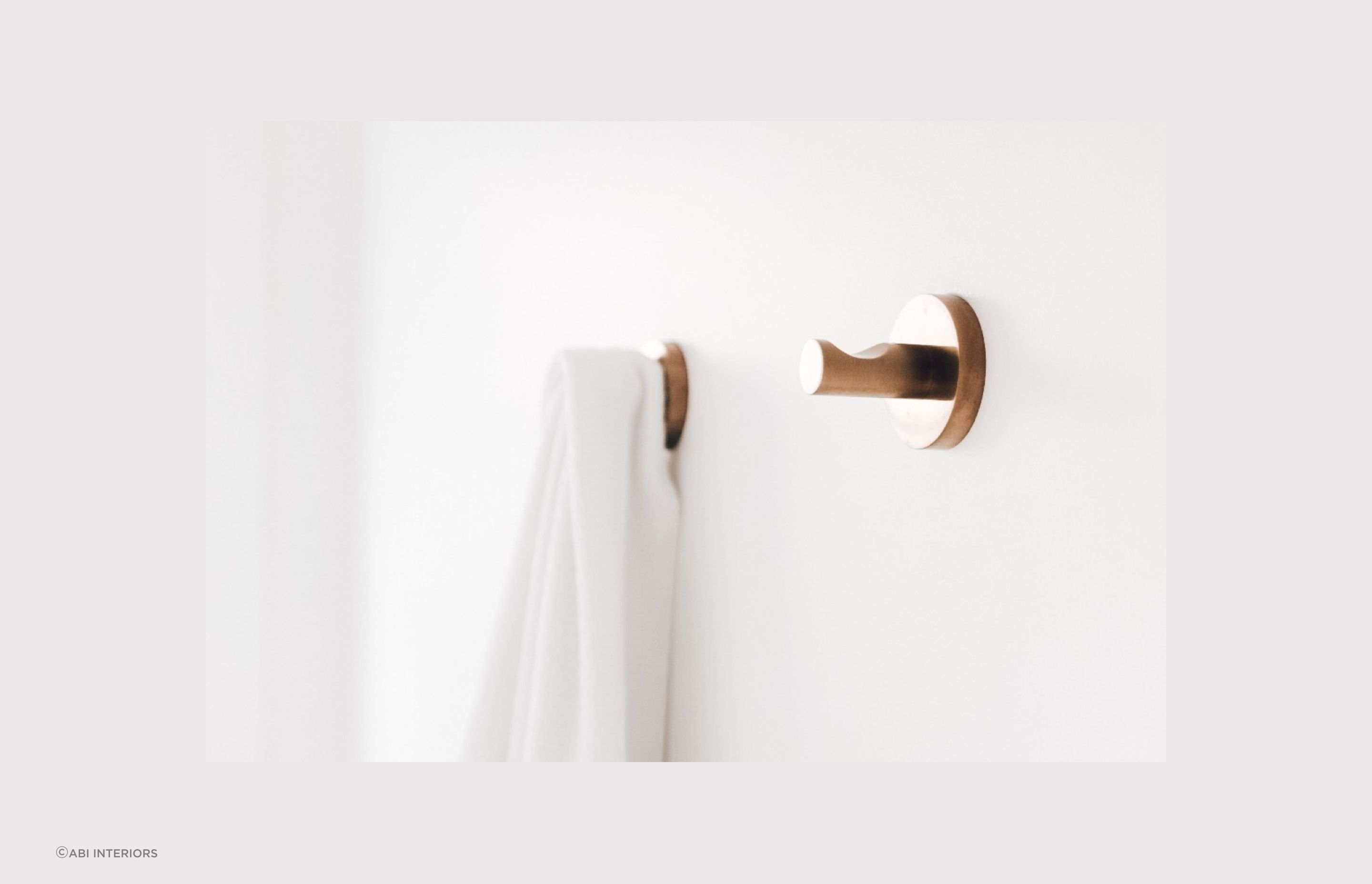 The Elysian Robe Hook in brushed copper offers a sophisticated solution for hanging your robes and towels.