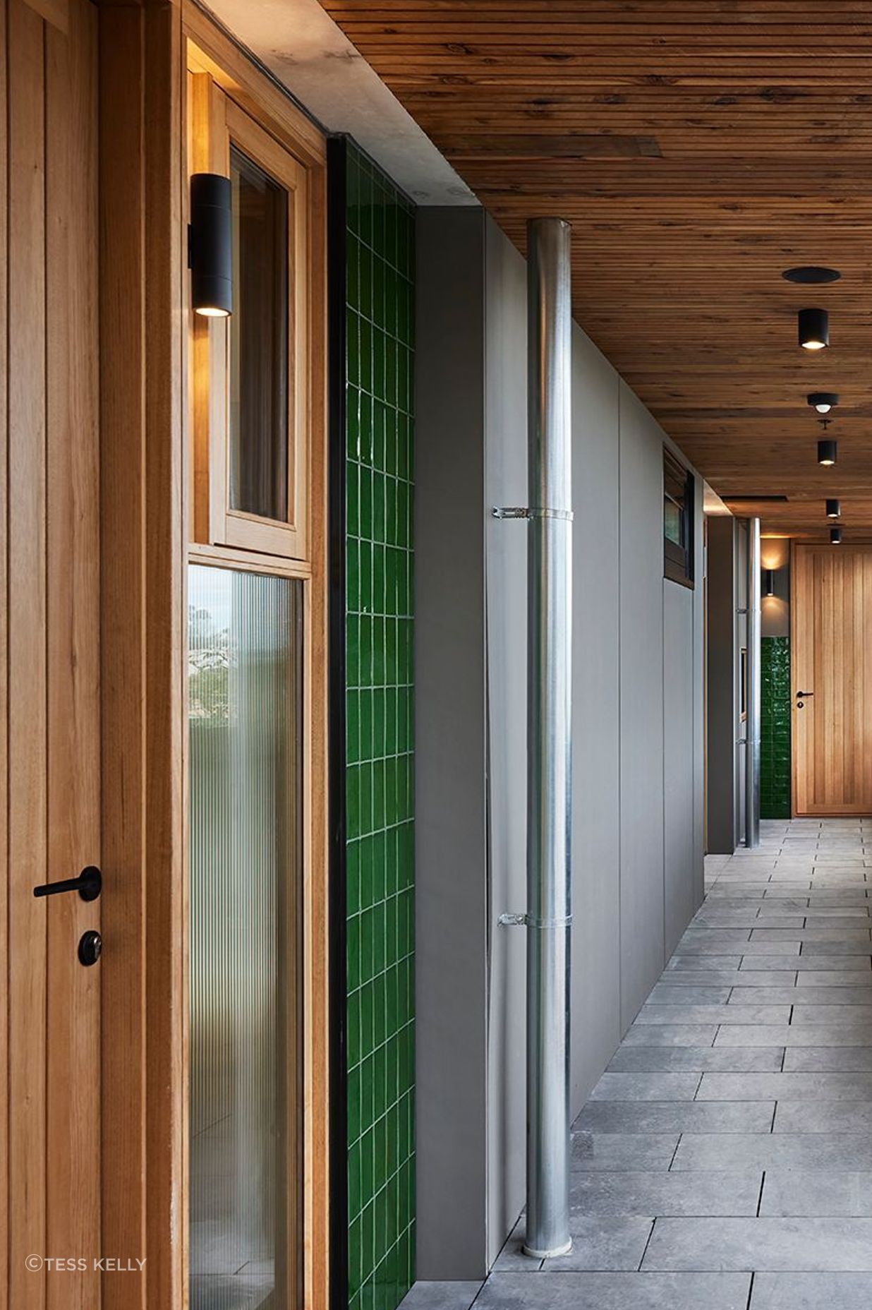 Timber doors add warmth to this apartment complex.